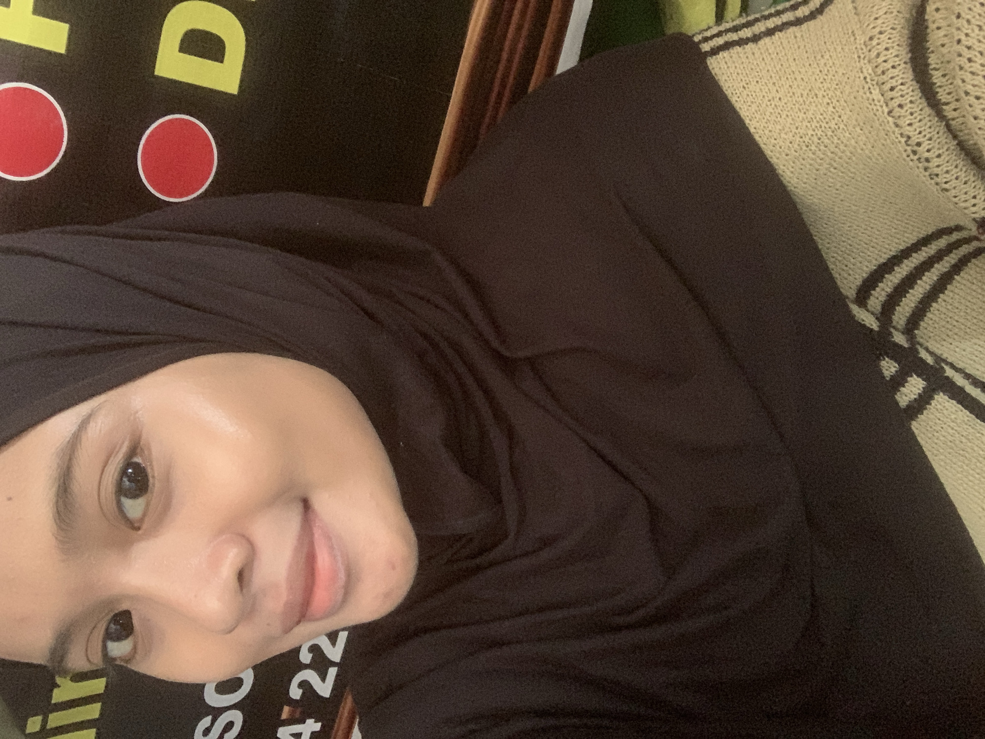 Selfie session in Sungai Meriam, dark hijab, signage backdrop