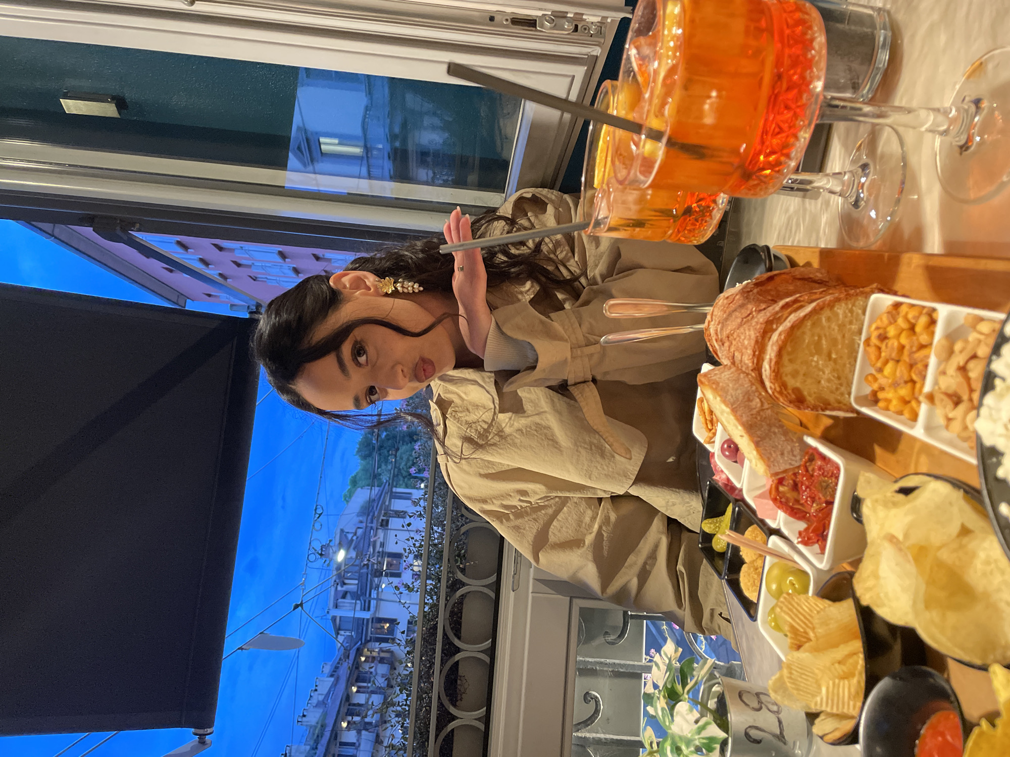 Woman documents aperitivo hour with cocktails in Milan