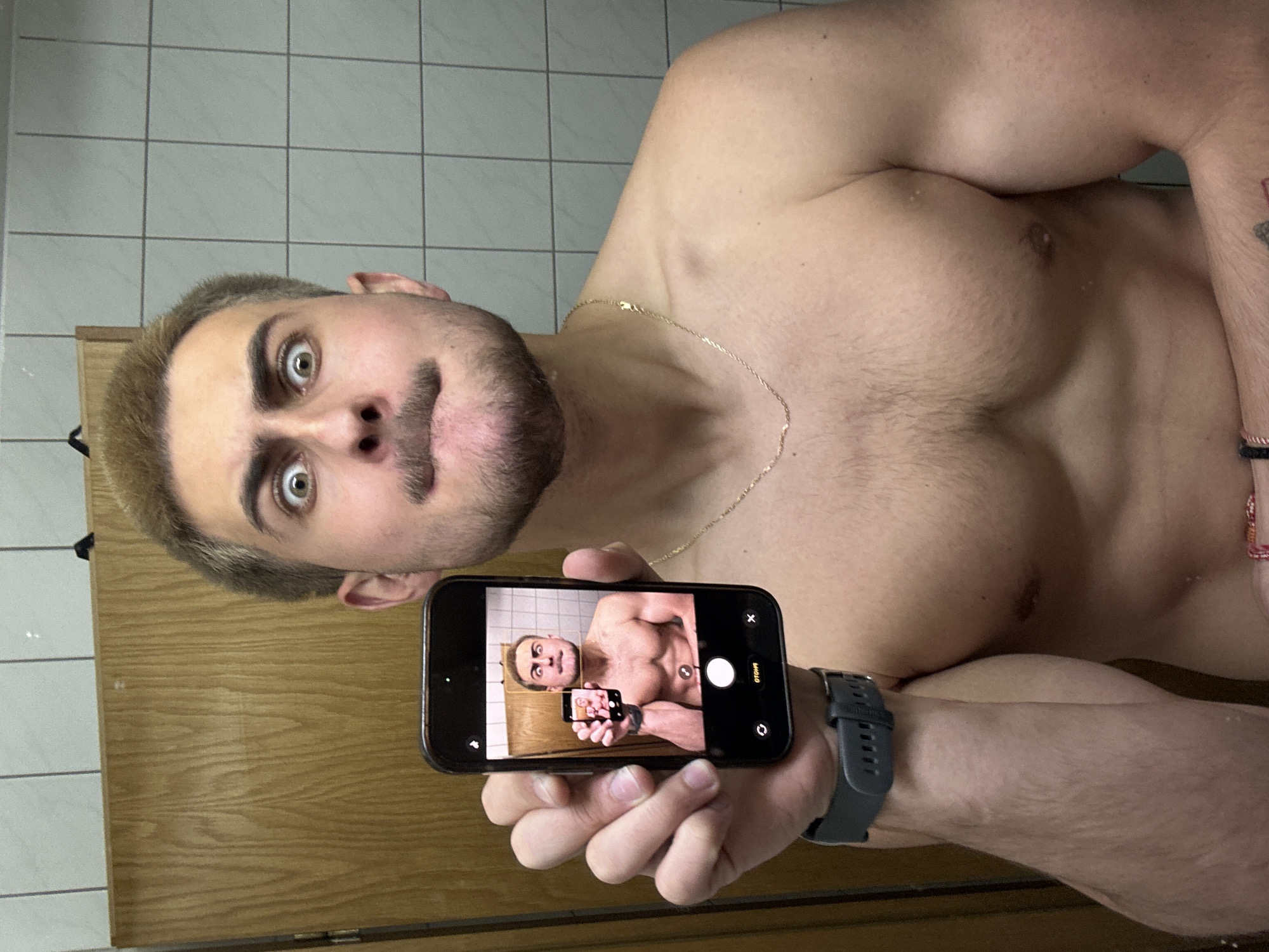 Man films drone flight indoors while taking bathroom selfies