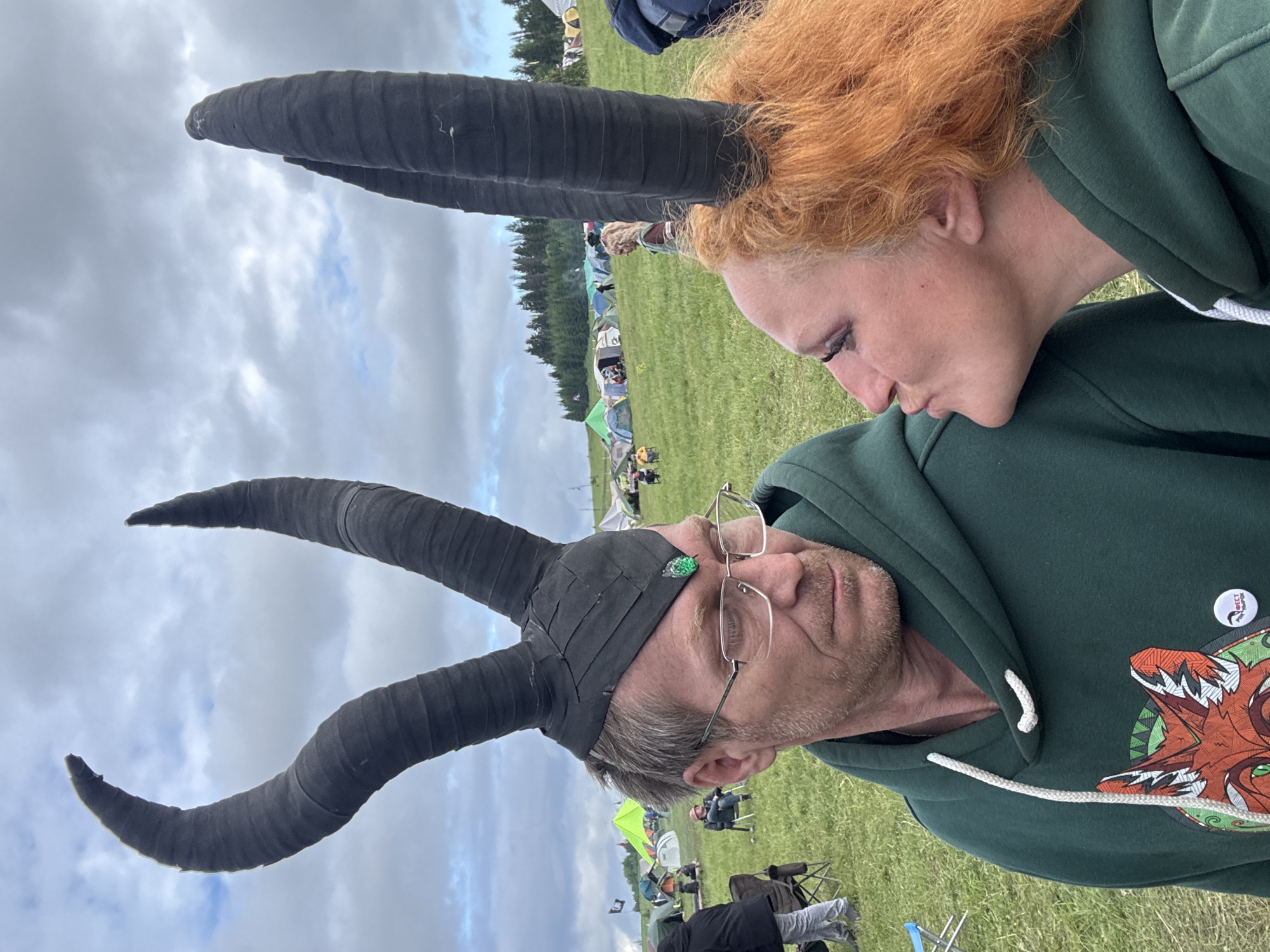 Two people interact in Russian field under overcast skies