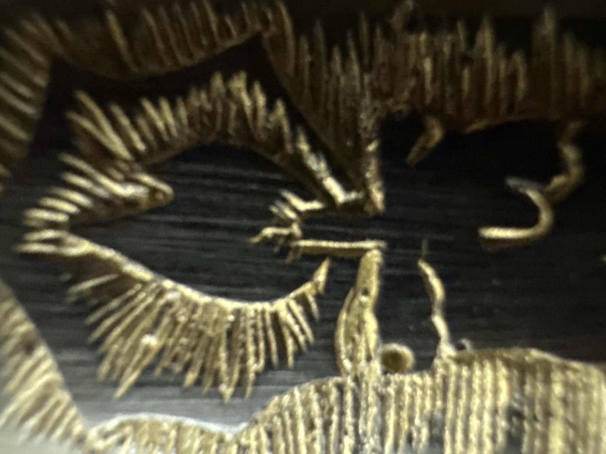 Close-up documentation of golden decorative artwork in Yerevan