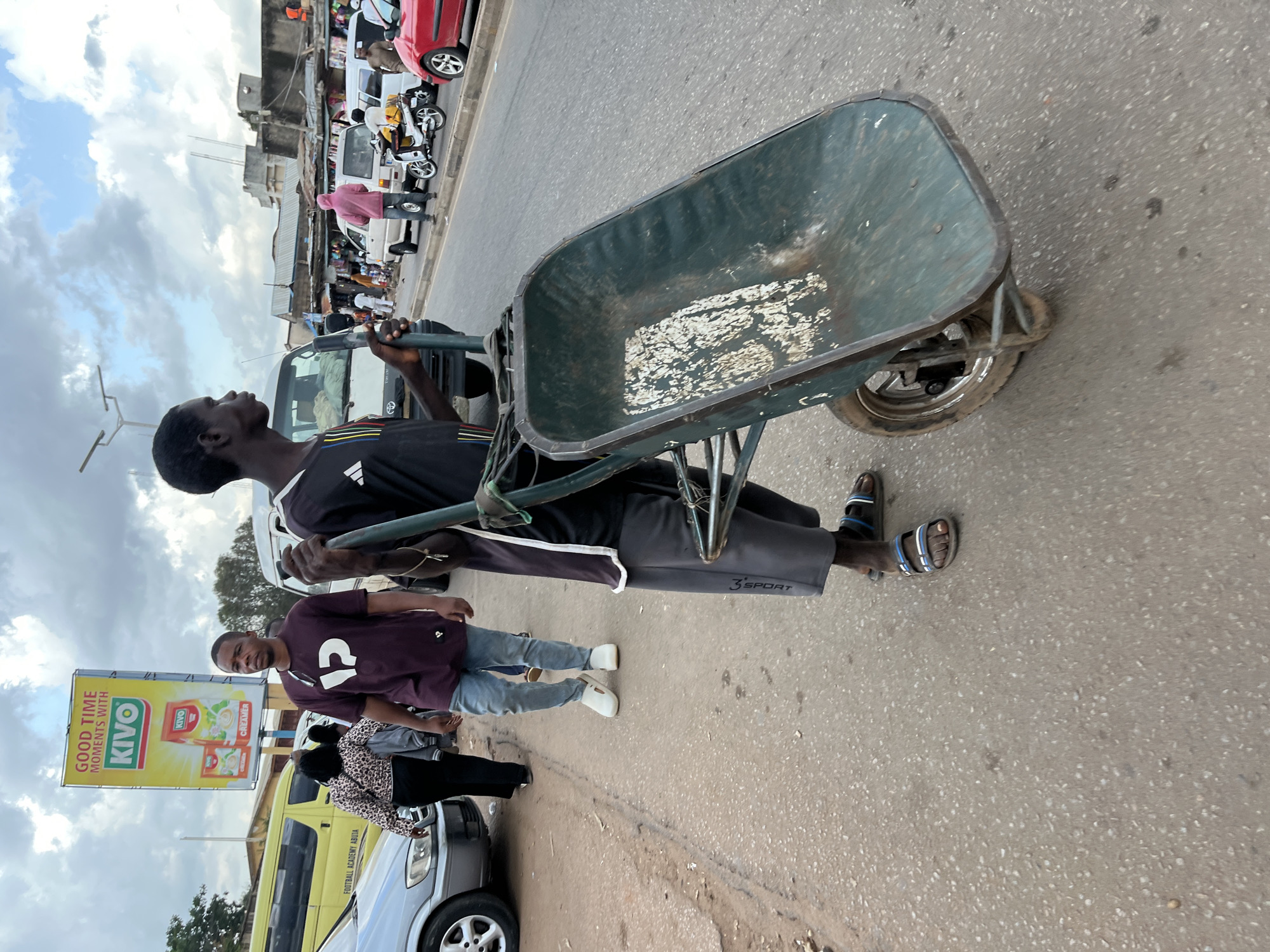 Street life on a Jos, Nigeria road on a cloudy afternoon