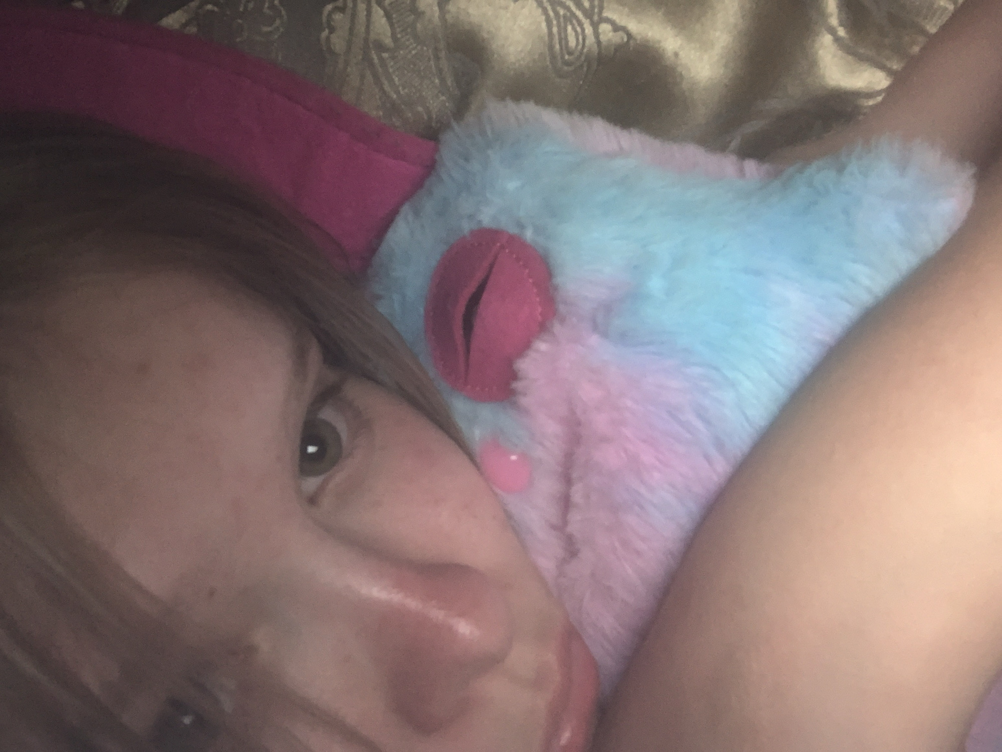 Young person documents evening selfie session with stuffed animal