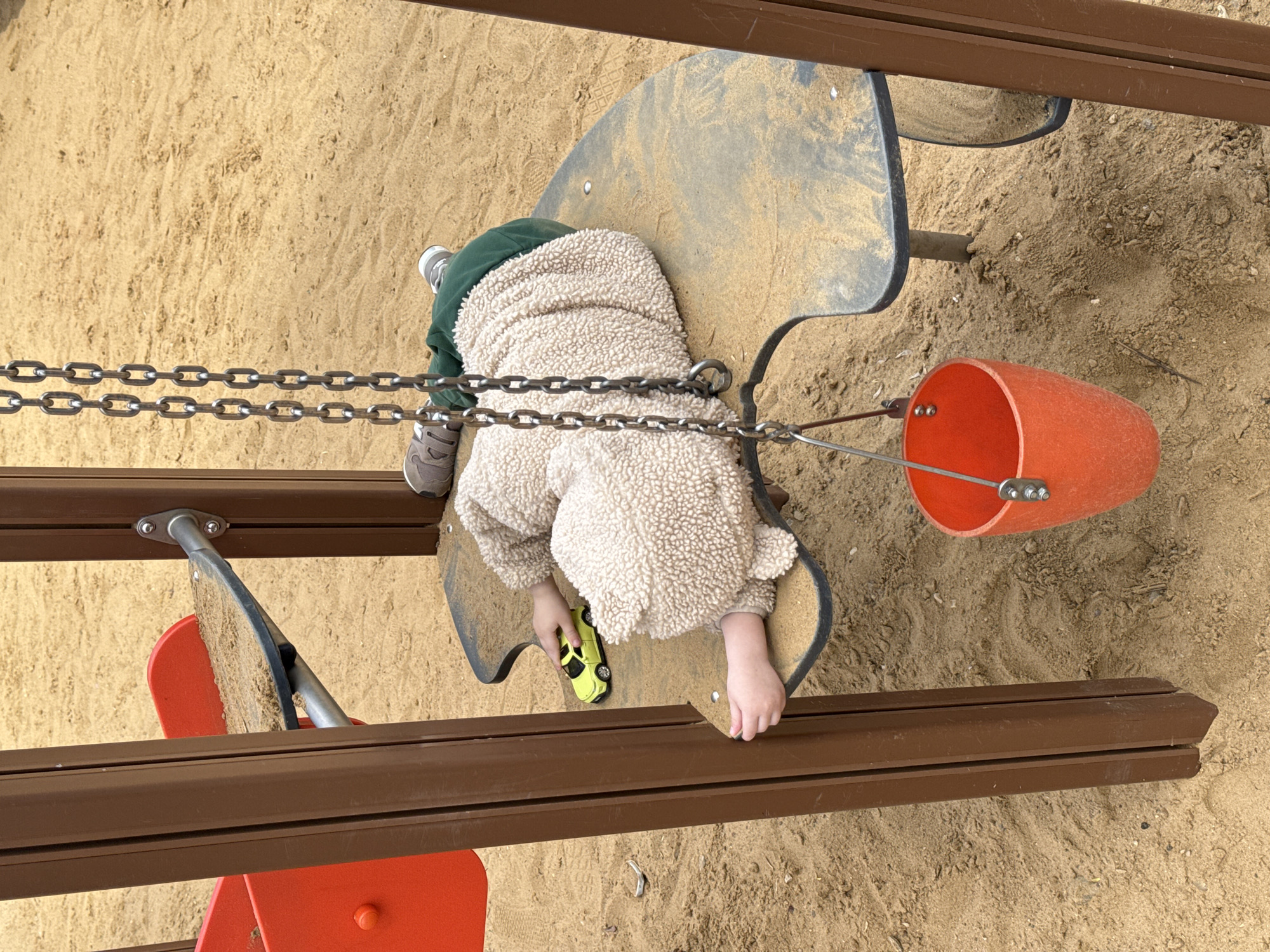 Child plays at Moscow playground amid spring blooms