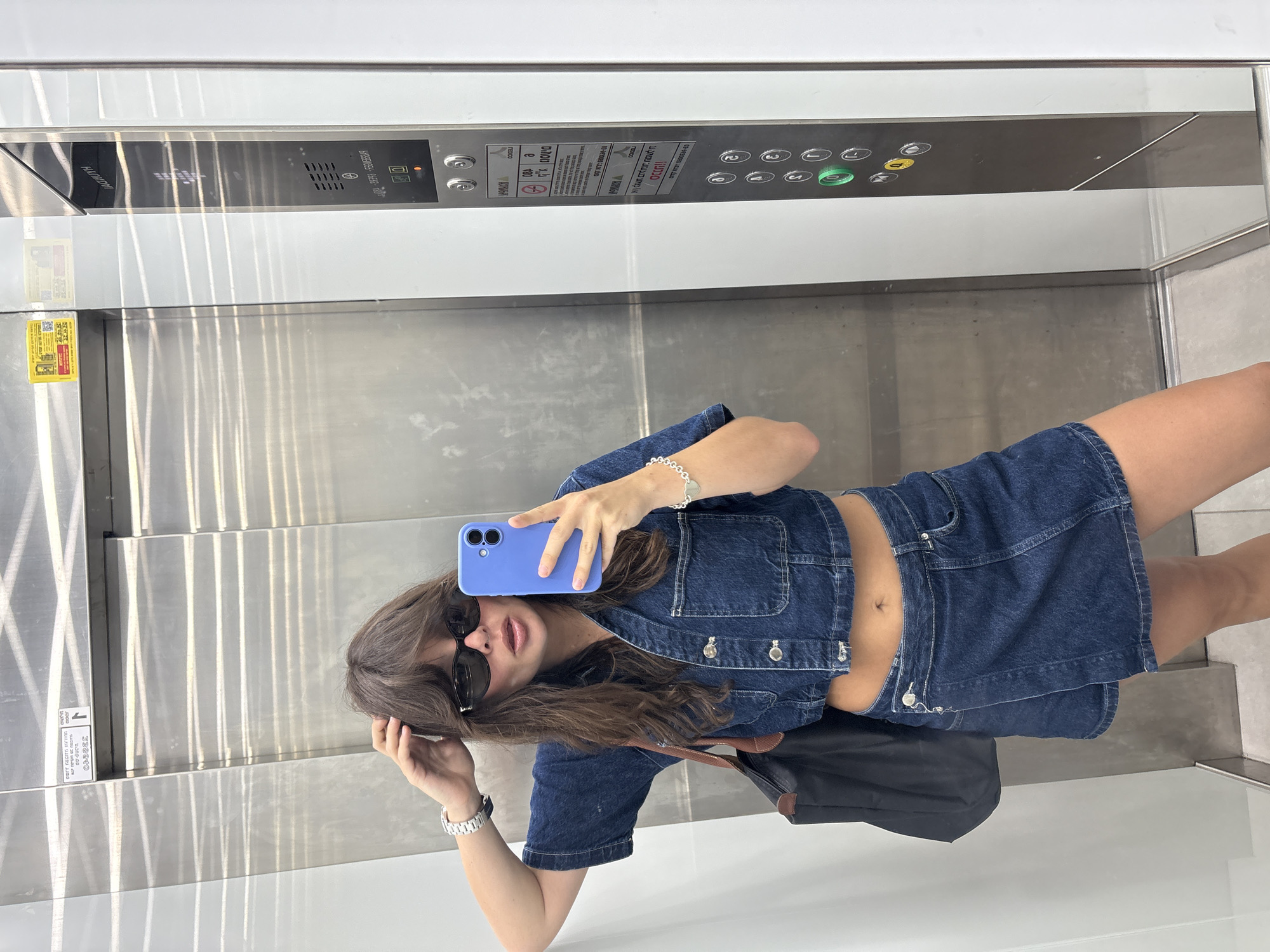 Elevator mirror selfie in Tel Aviv, denim outfit.