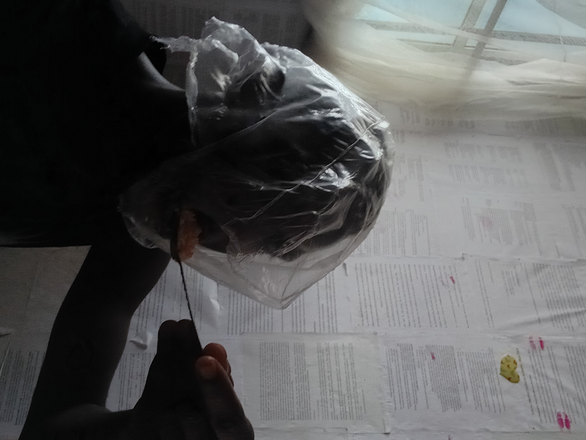 Person eating meal on floor in Akwete, Nigeria