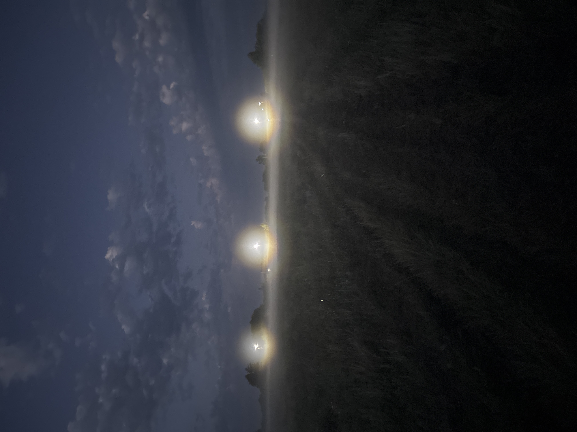 Fog and lights in a field near Ворошиловка at dusk
