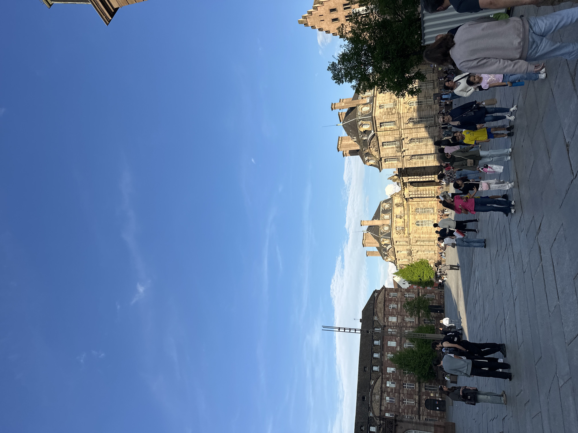 Street performer, tourists document typical afternoon at Strasbourg Cathedral
