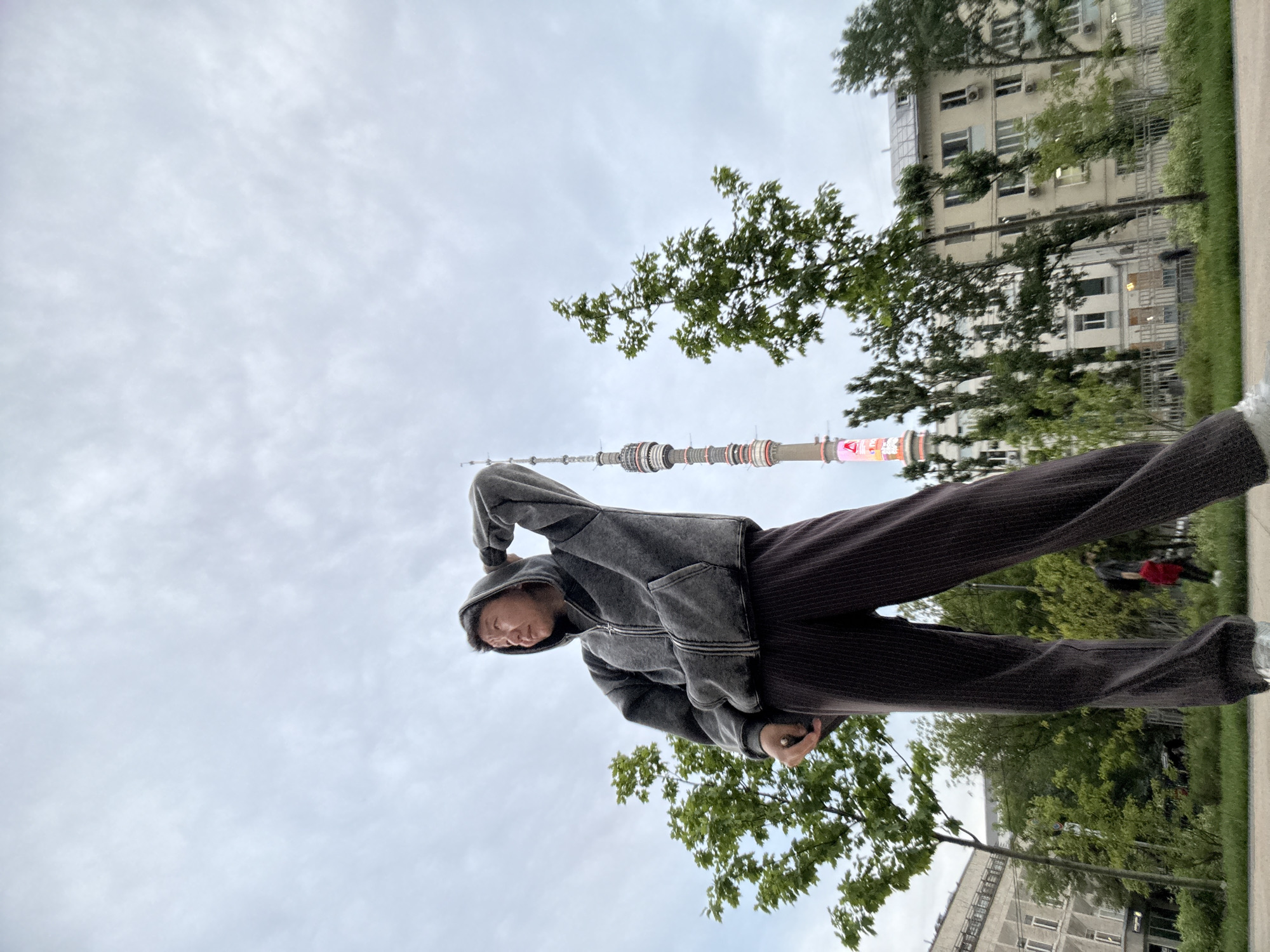 Casual outdoor moment in Khimki, hand raised, looking aside