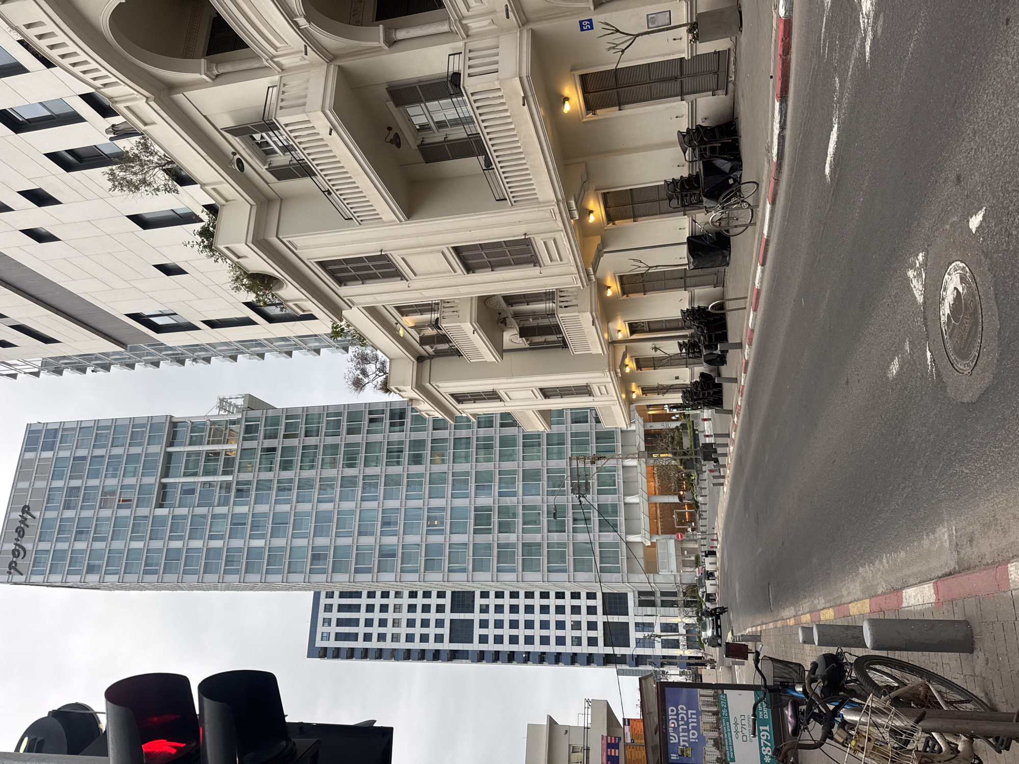 Tel Aviv street scene shows contrasting modern and traditional architecture
