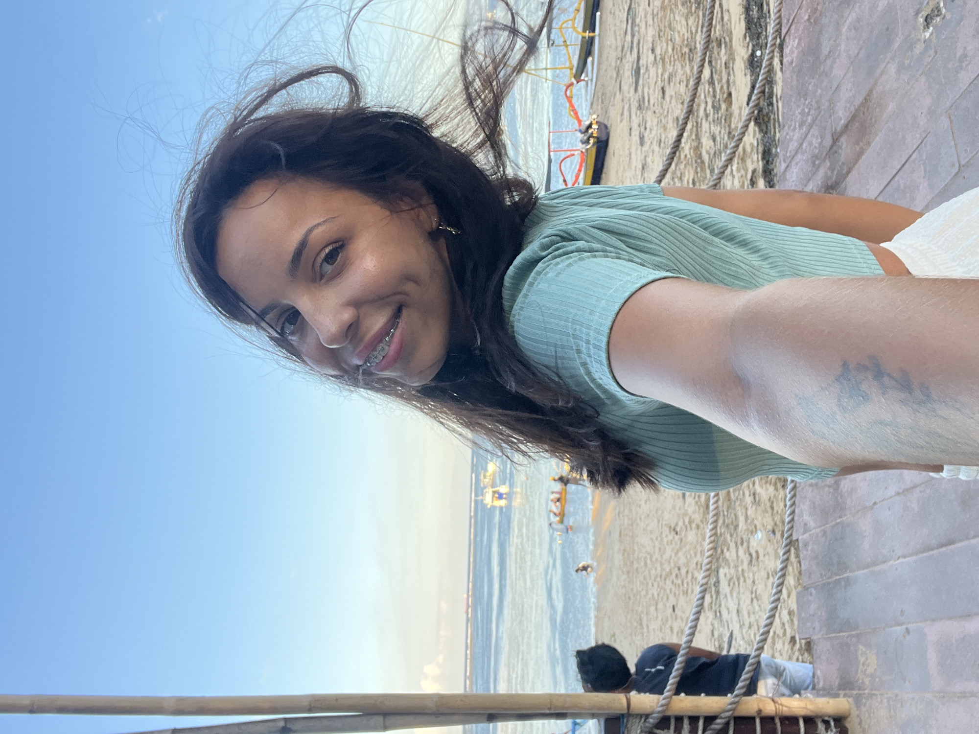 Woman takes selfie at Denpasar beach location