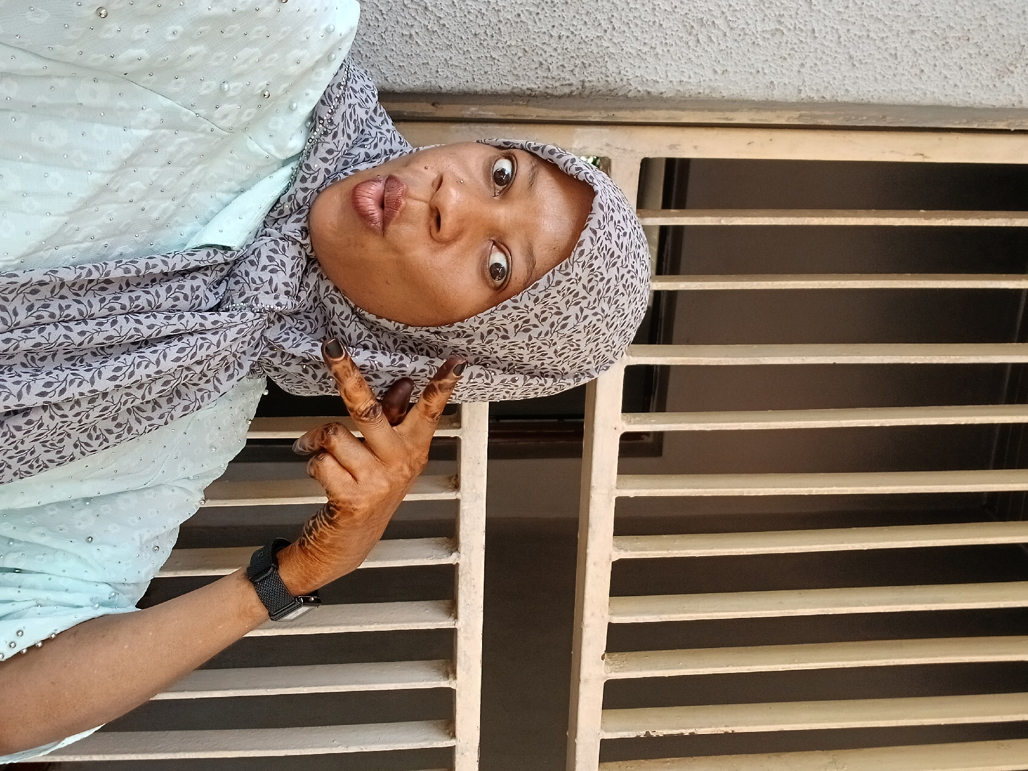 Woman photographed in various orientations outside Shaba building