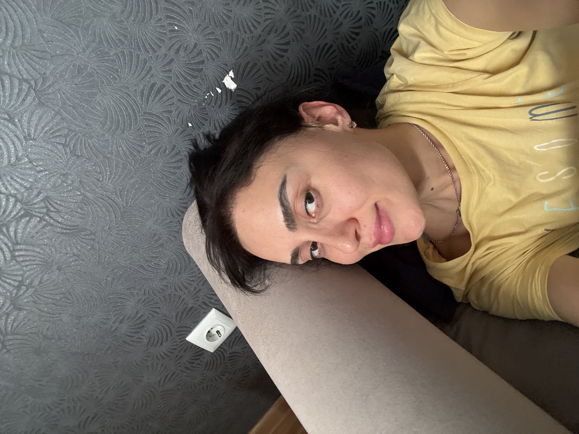 Person in yellow shirt captured in quiet moments around Tbilisi home