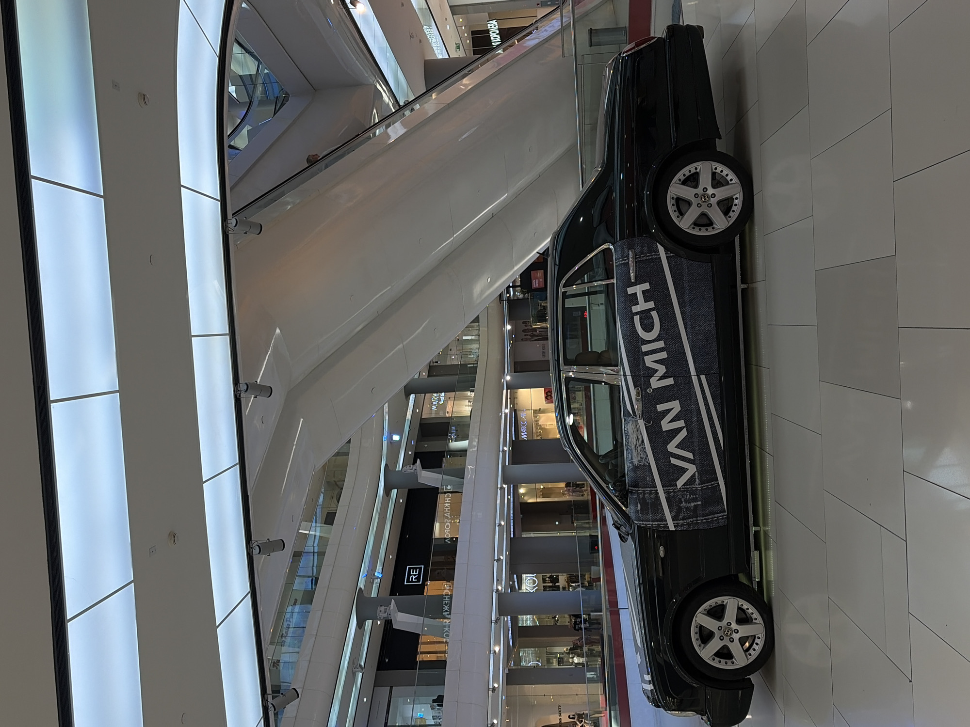 Shopping mall activity documented in Krasnodar featuring luxury car display