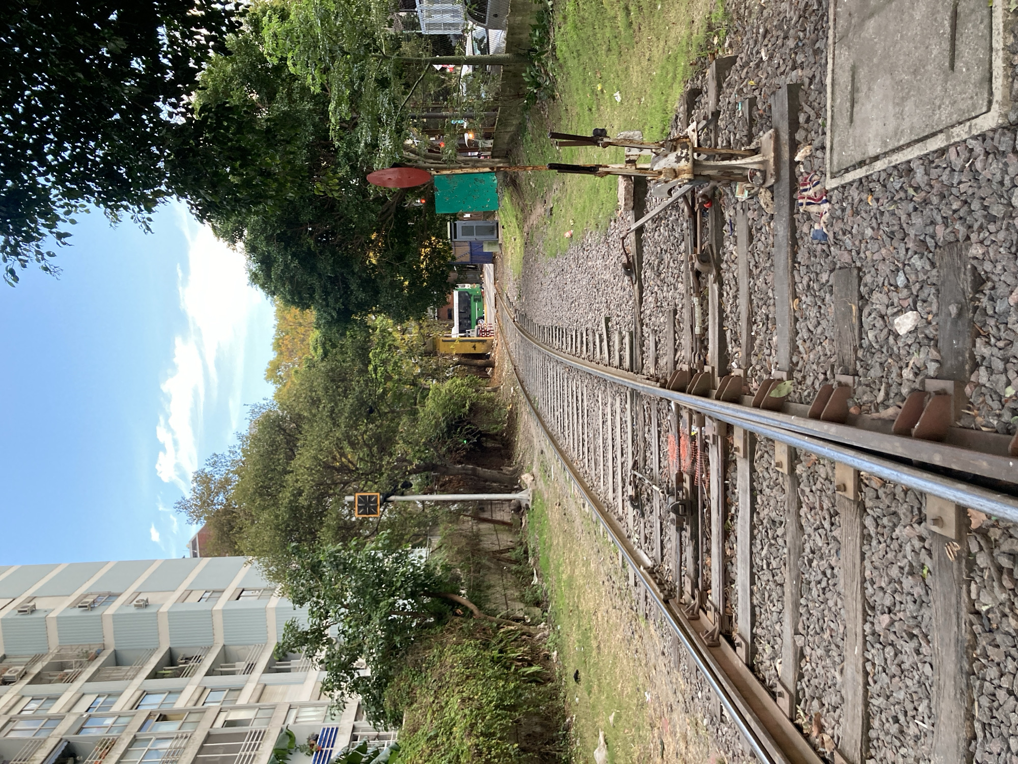 Person walks railway tracks in Buenos Aires evening