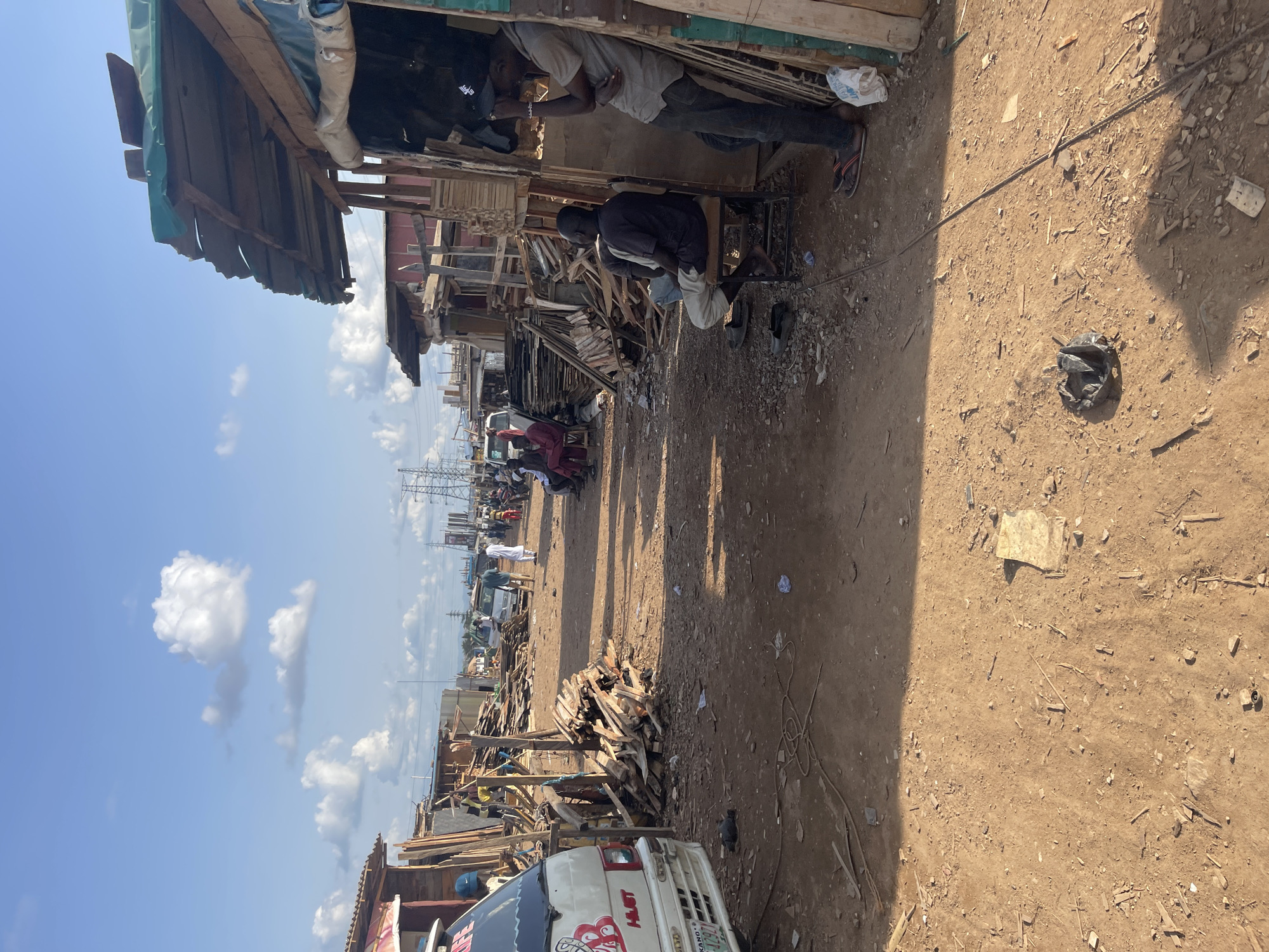 Outdoor marketplace activity documented in Abuja industrial district