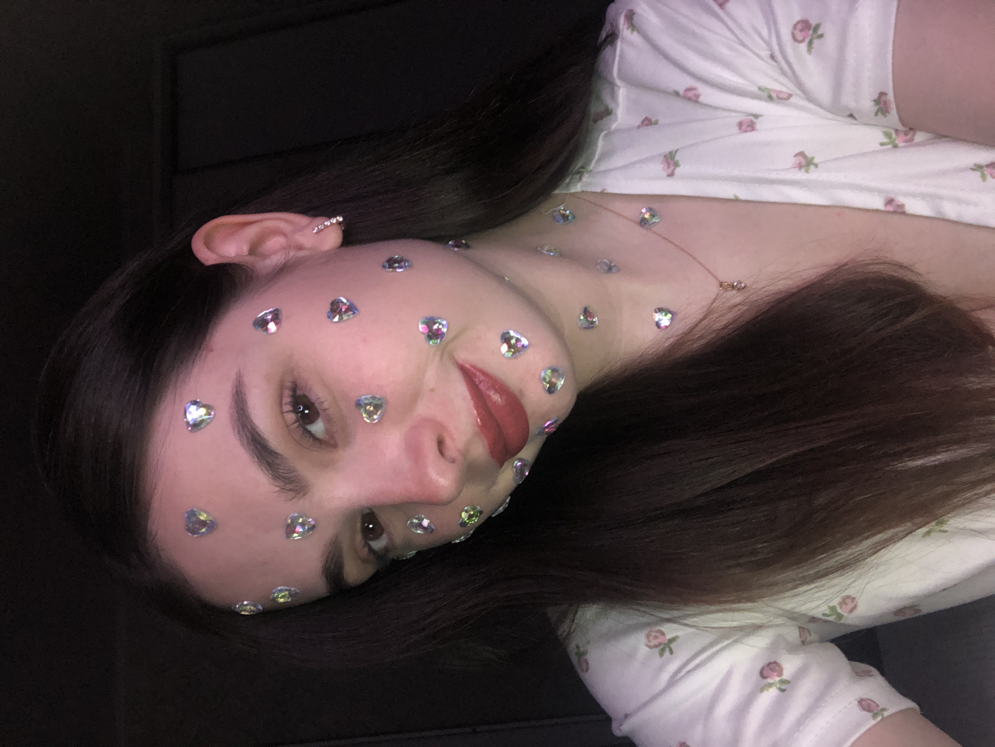 Woman photographed with decorative heart stickers in Noviy, Russia