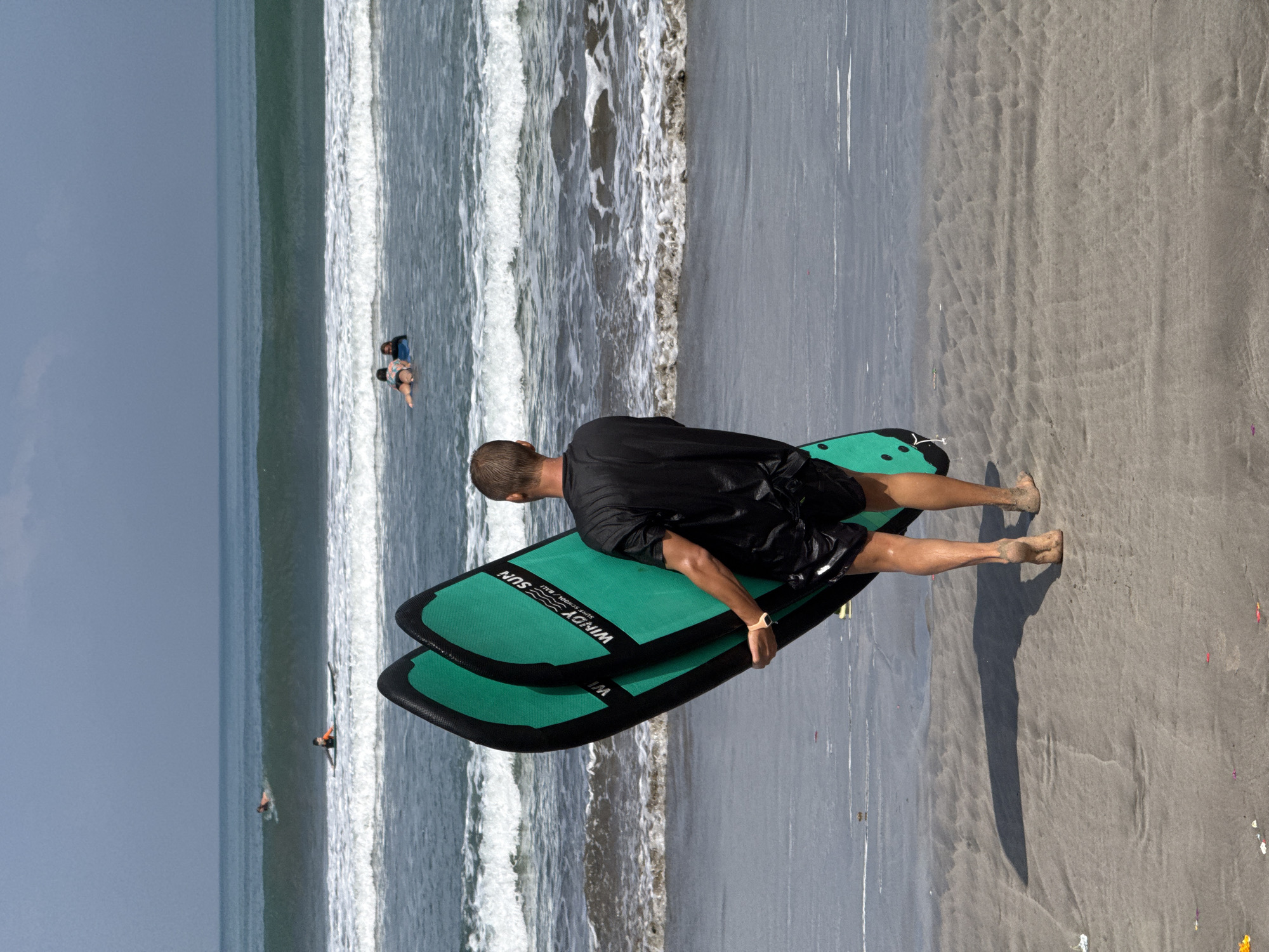 Early morning surf gathering at Kuta Beach, Indonesia