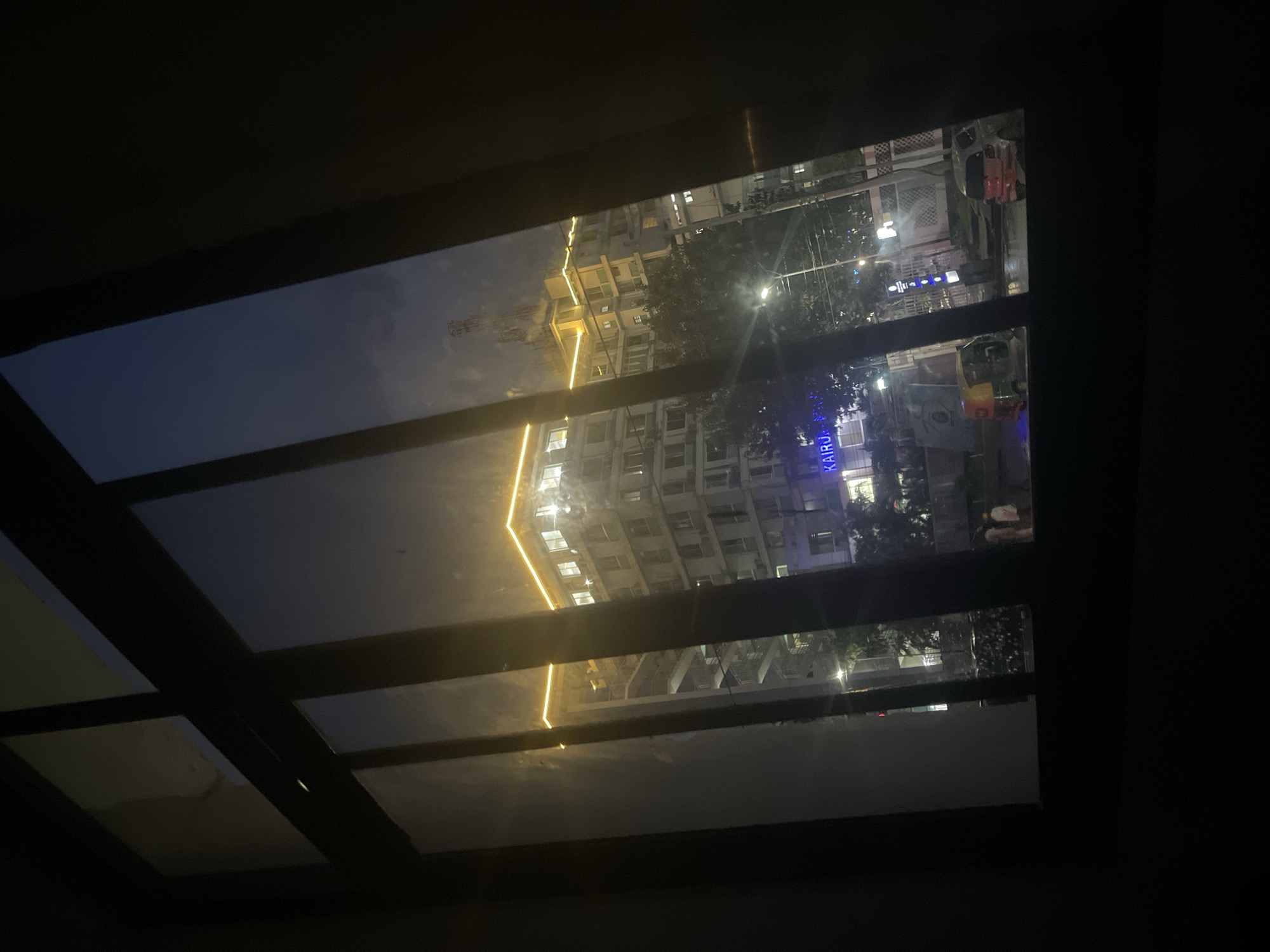 Nighttime cityscape view captured through window in Dar es-Salaam