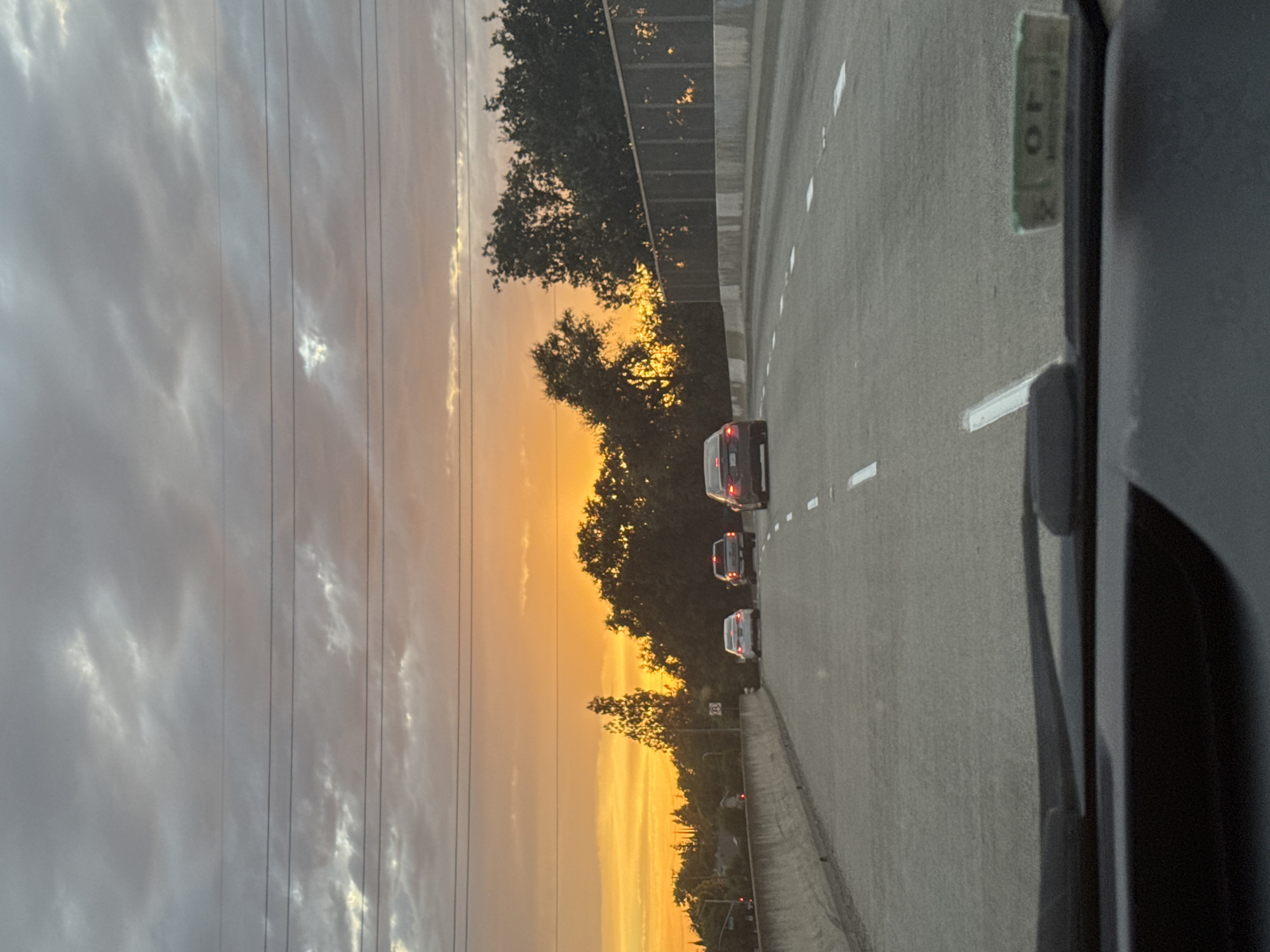 Highway drive through Foothill Farms under a vivid sunset sky