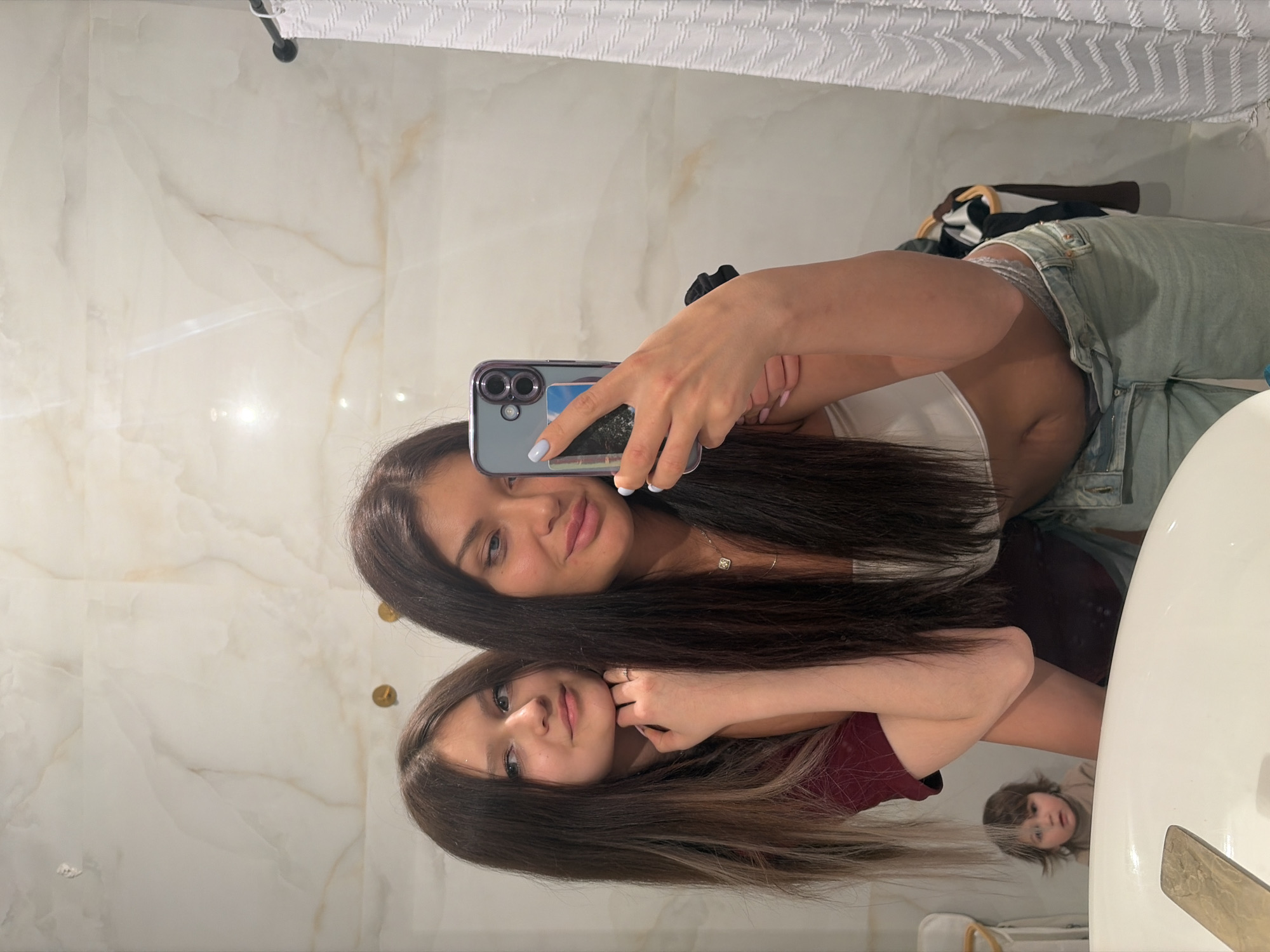 Two women take bathroom selfies in Moscow