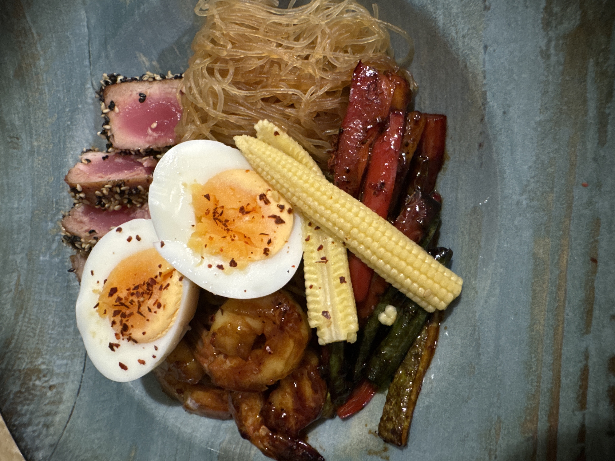 Asian-inspired dish served in a blue-gray bowl, Pomorie