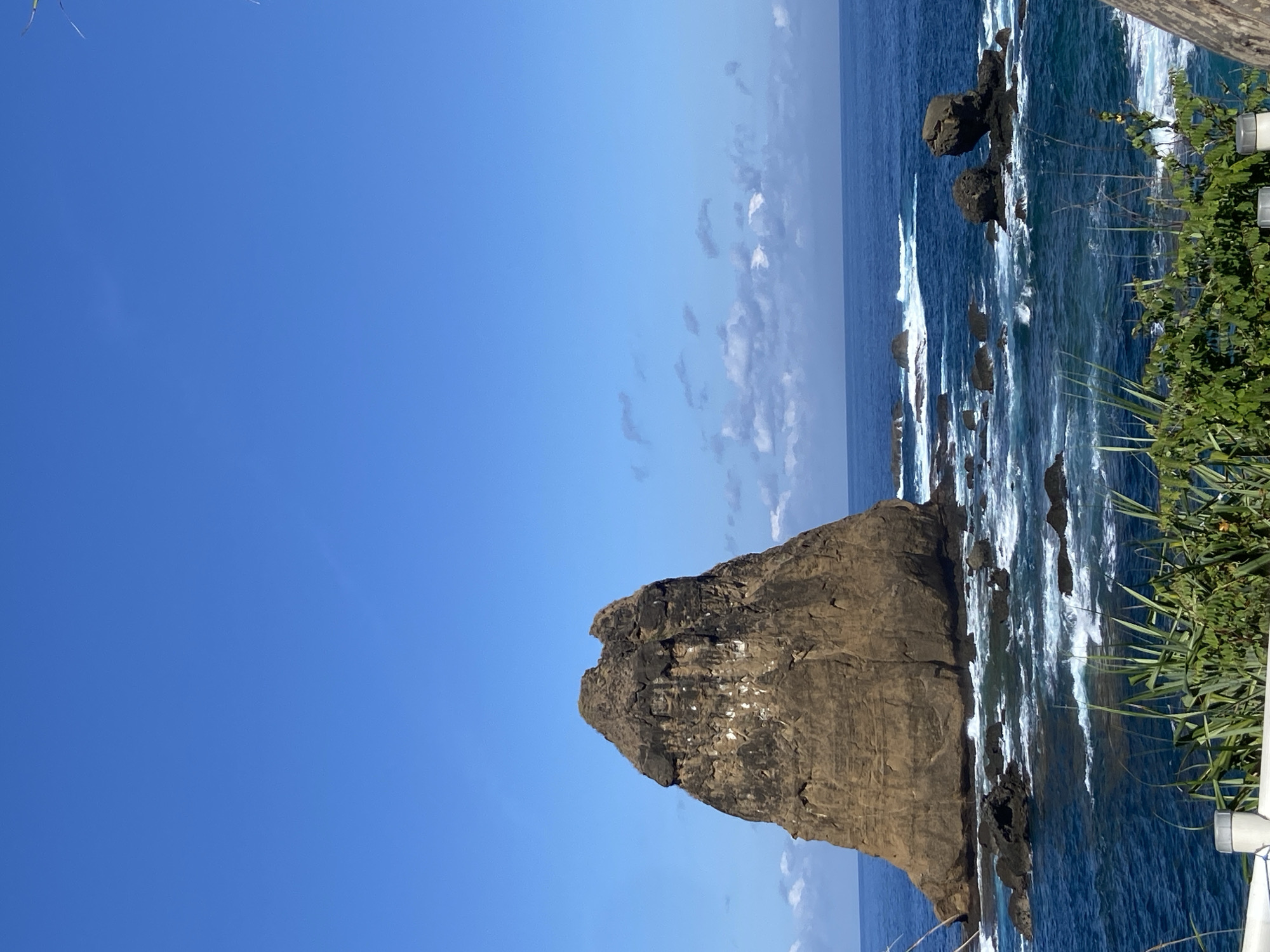 Tourists enjoy scenic coastal views at Indonesian lookout point