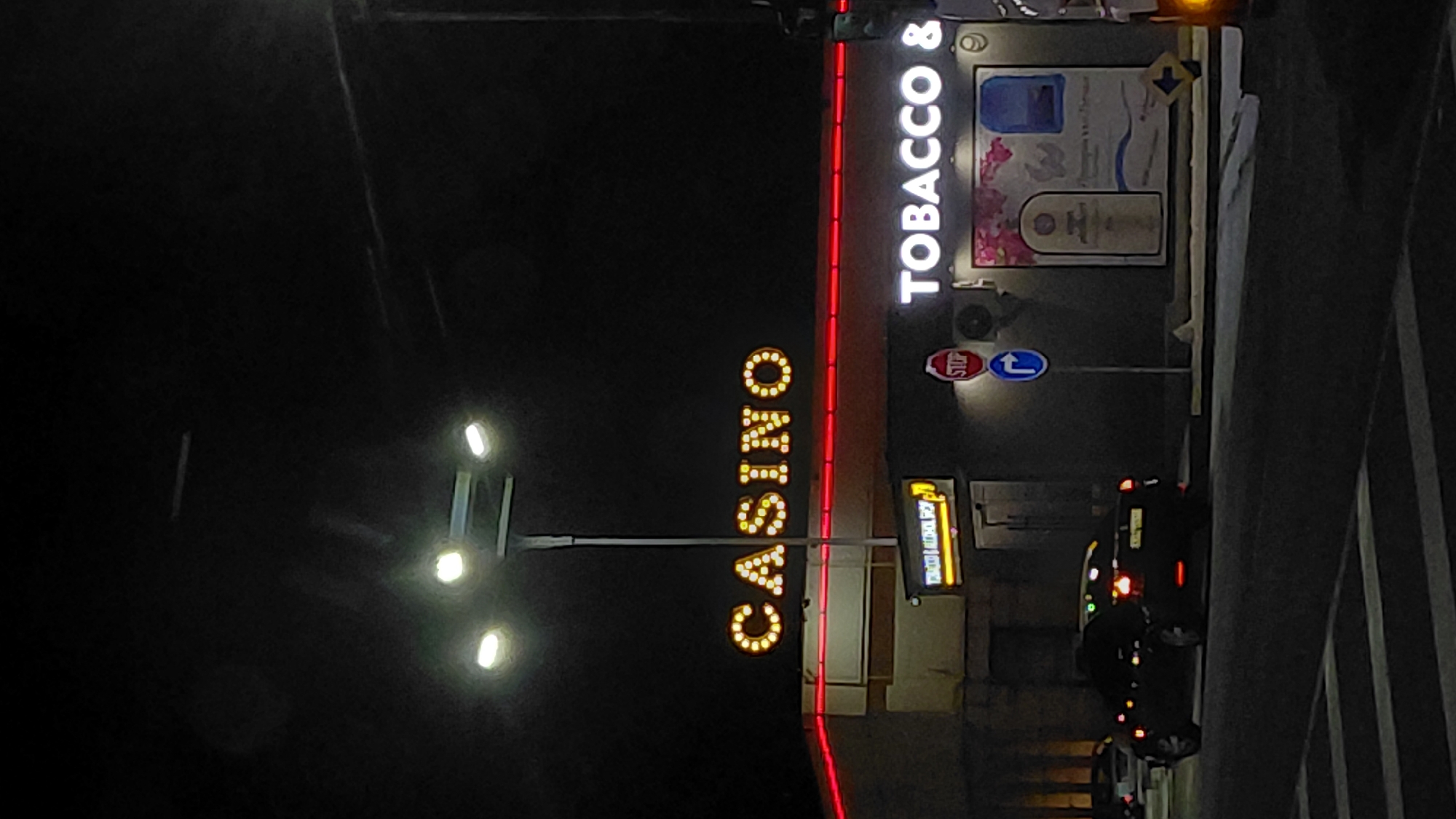 Nighttime casino and tobacco store signs documented by witness
