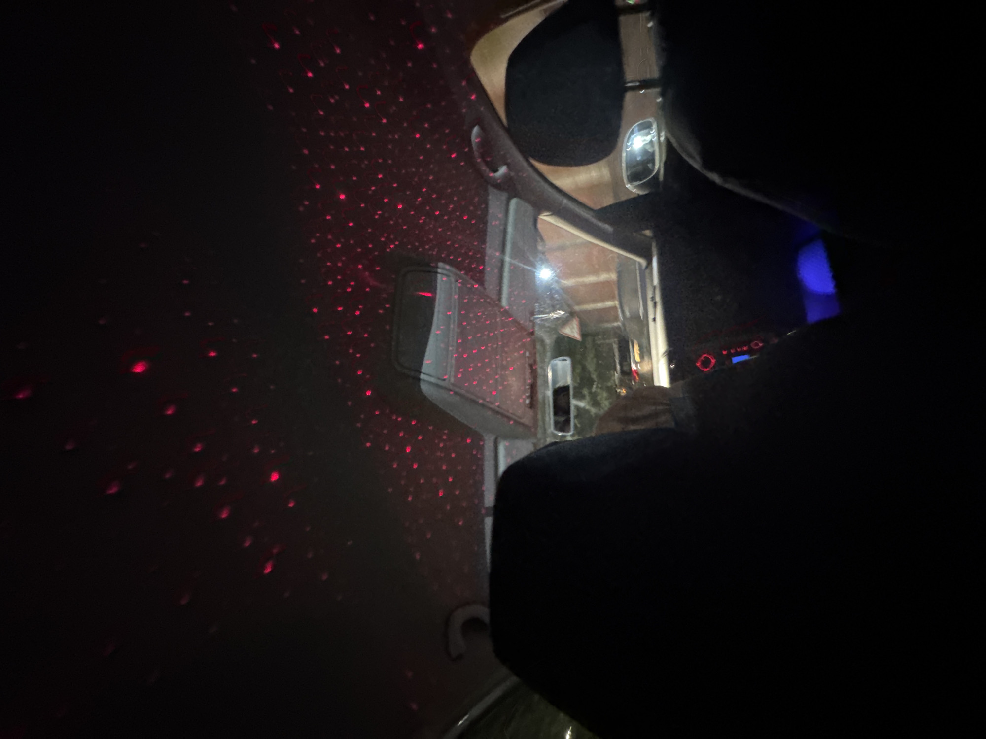 Red laser lights turn a car ceiling into a starry night