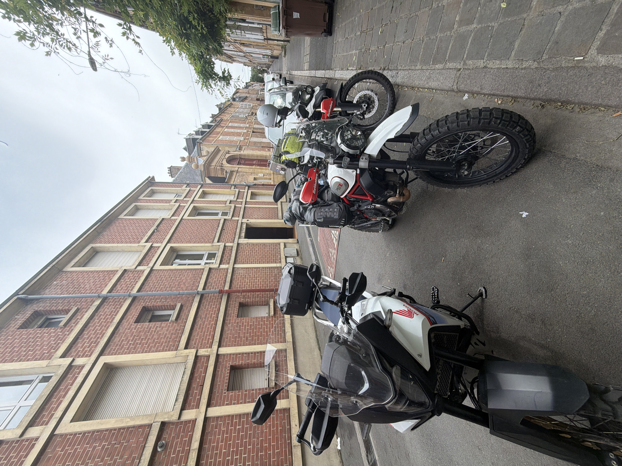 Motorcycles parked on cobblestone street in Charleville-Mézières