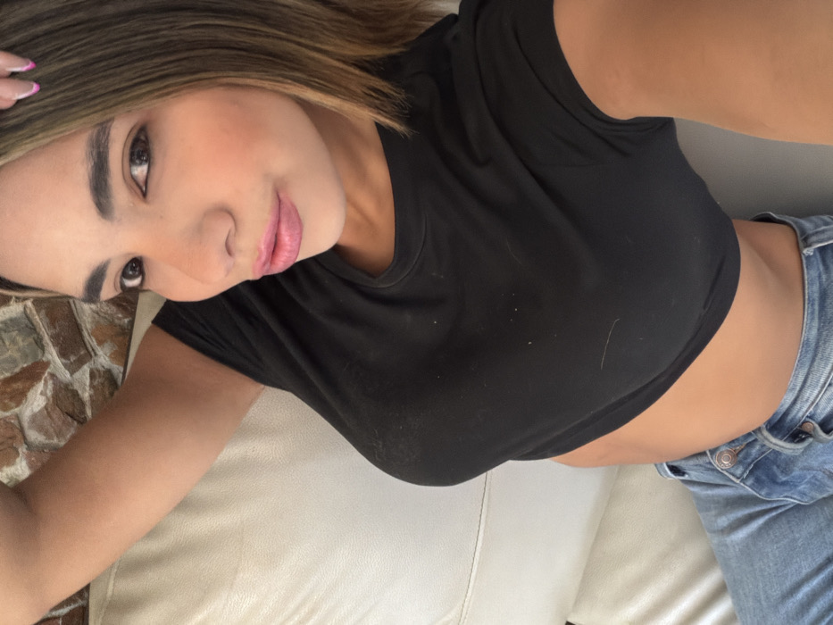 Woman takes selfie on couch in Caracas