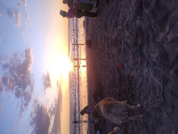 Families enjoy sunset beach time in Iquique, Chile