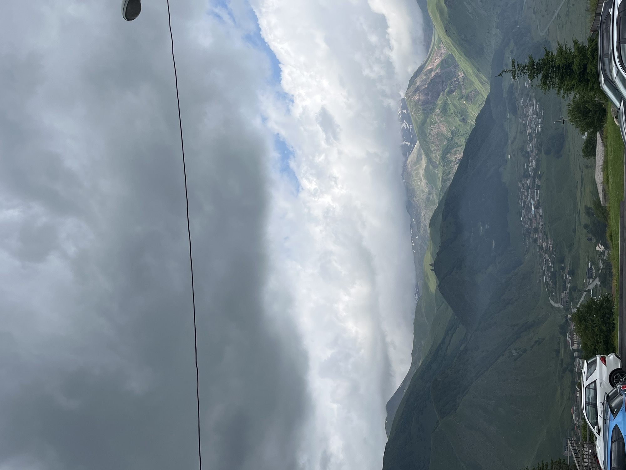 Stepantsminda valley town under heavy clouds, Georgian mountains