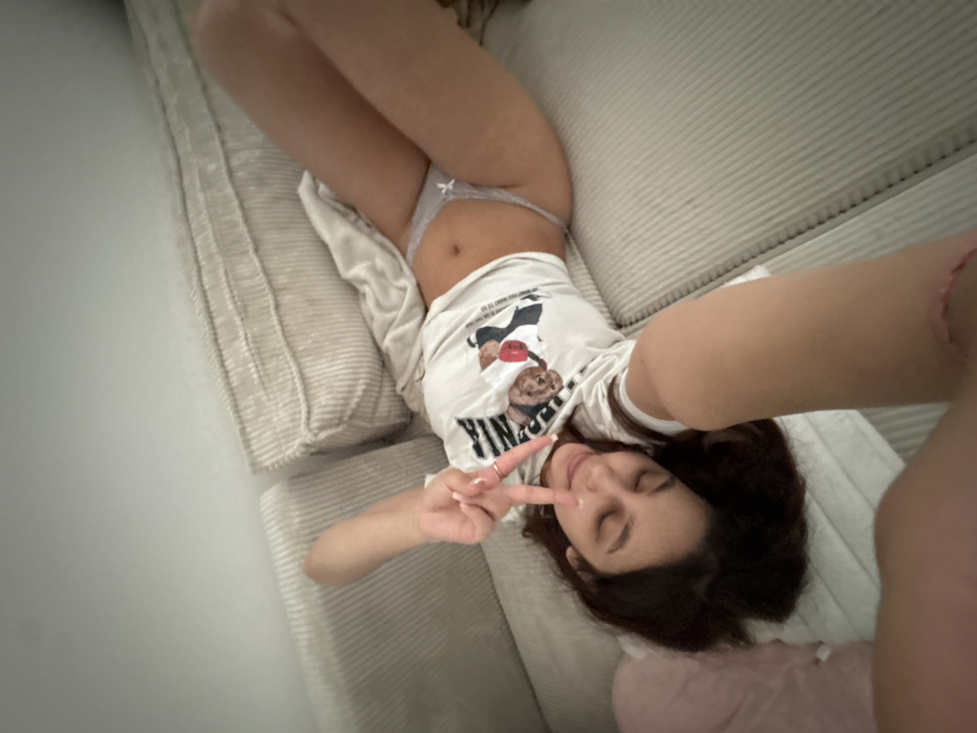 Woman takes relaxed selfies on sofa in Mönchengladbach