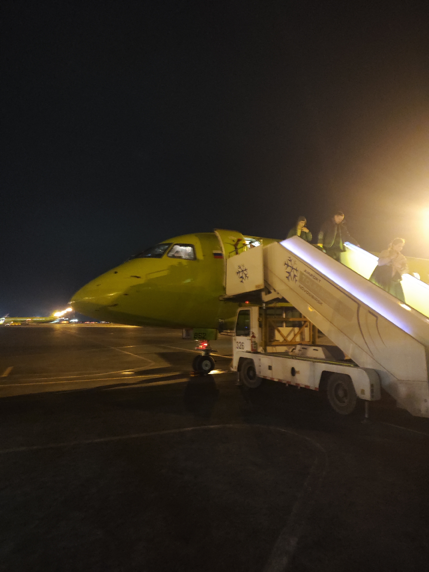 S7 Airlines flight arrives at Novosibirsk Airport, passengers disembark