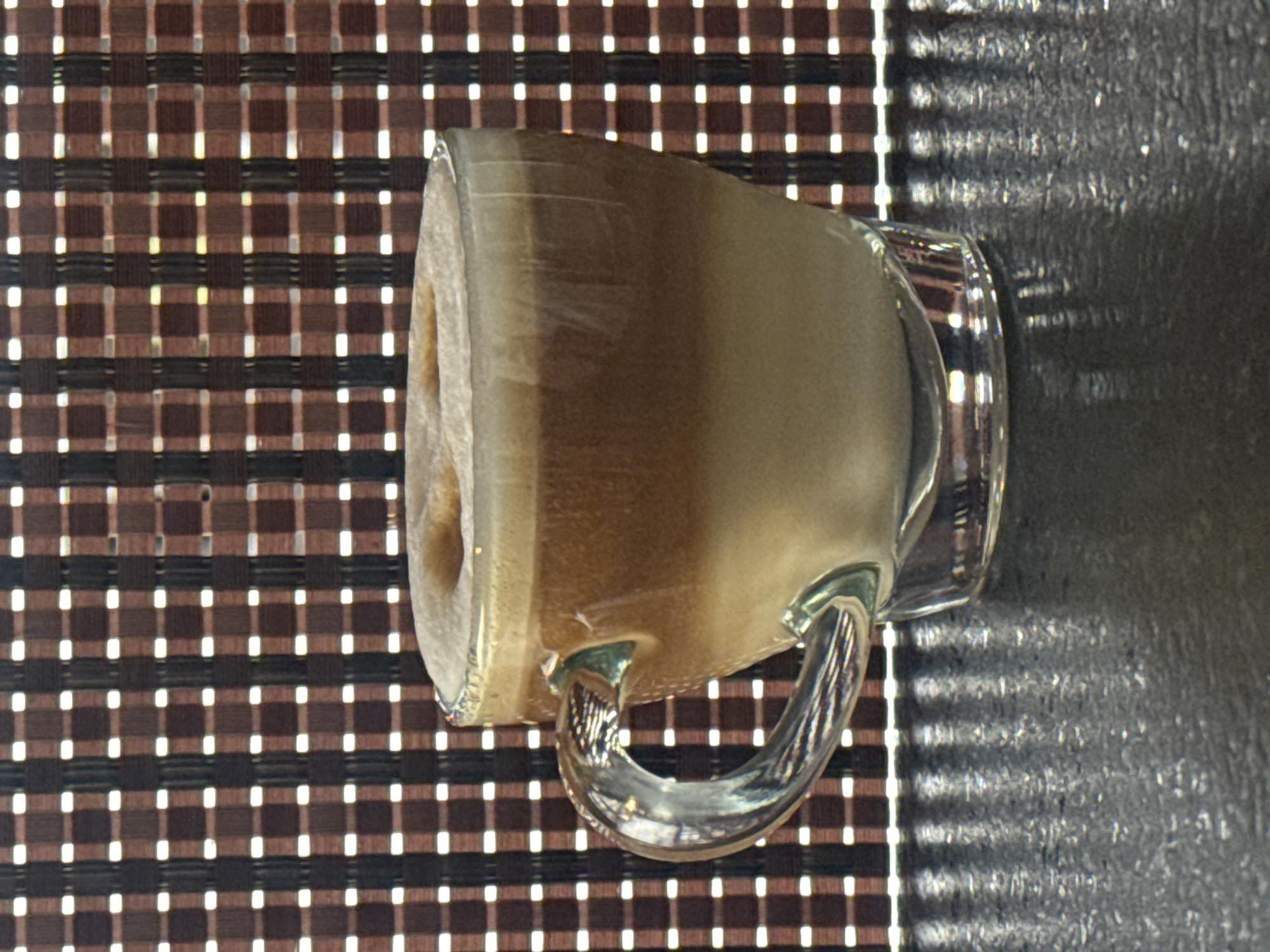 Coffee moment captured on checkered surface April 20