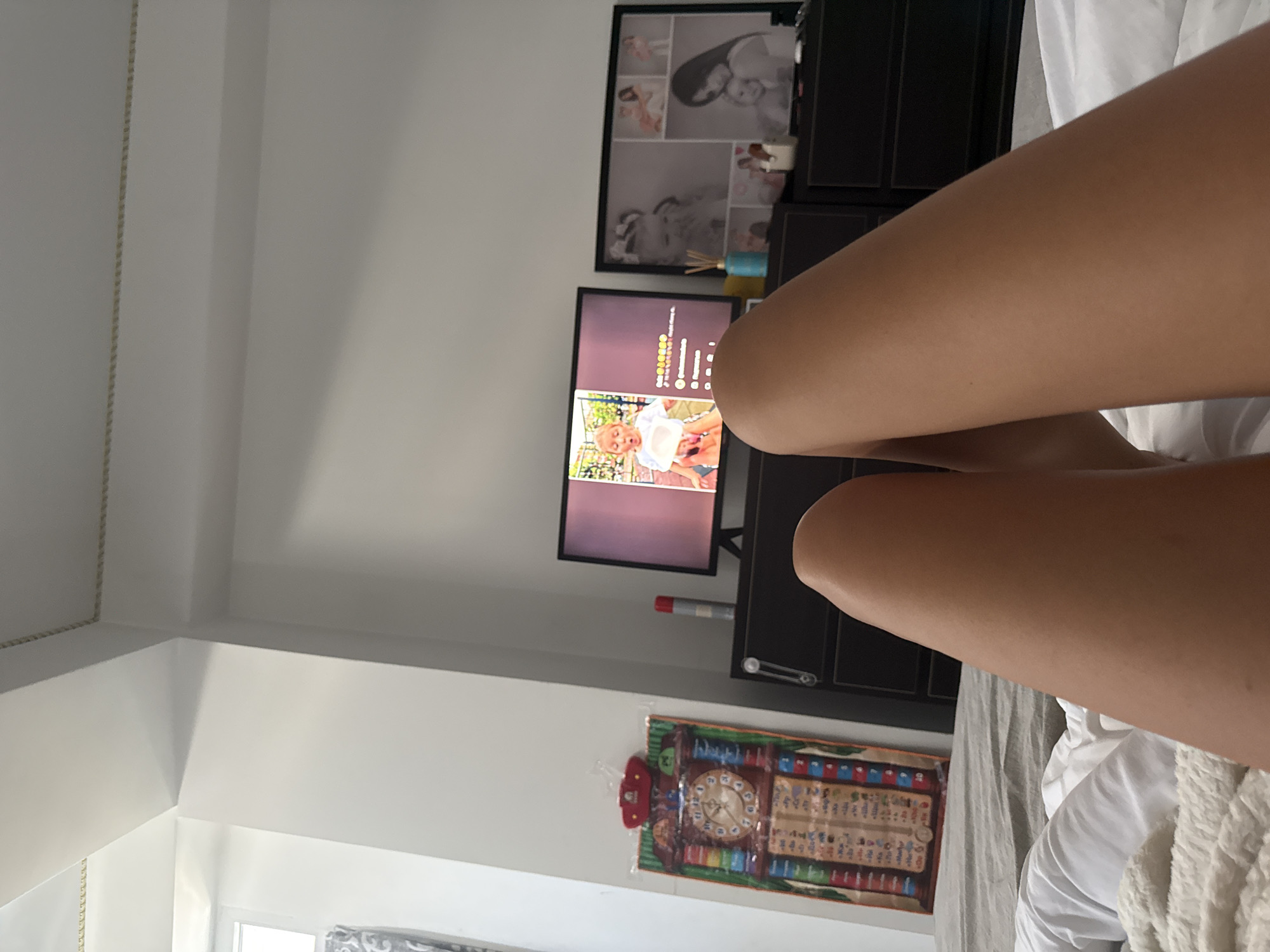 Quiet afternoon in a Chișinău bedroom, TV on, kid watching cartoons
