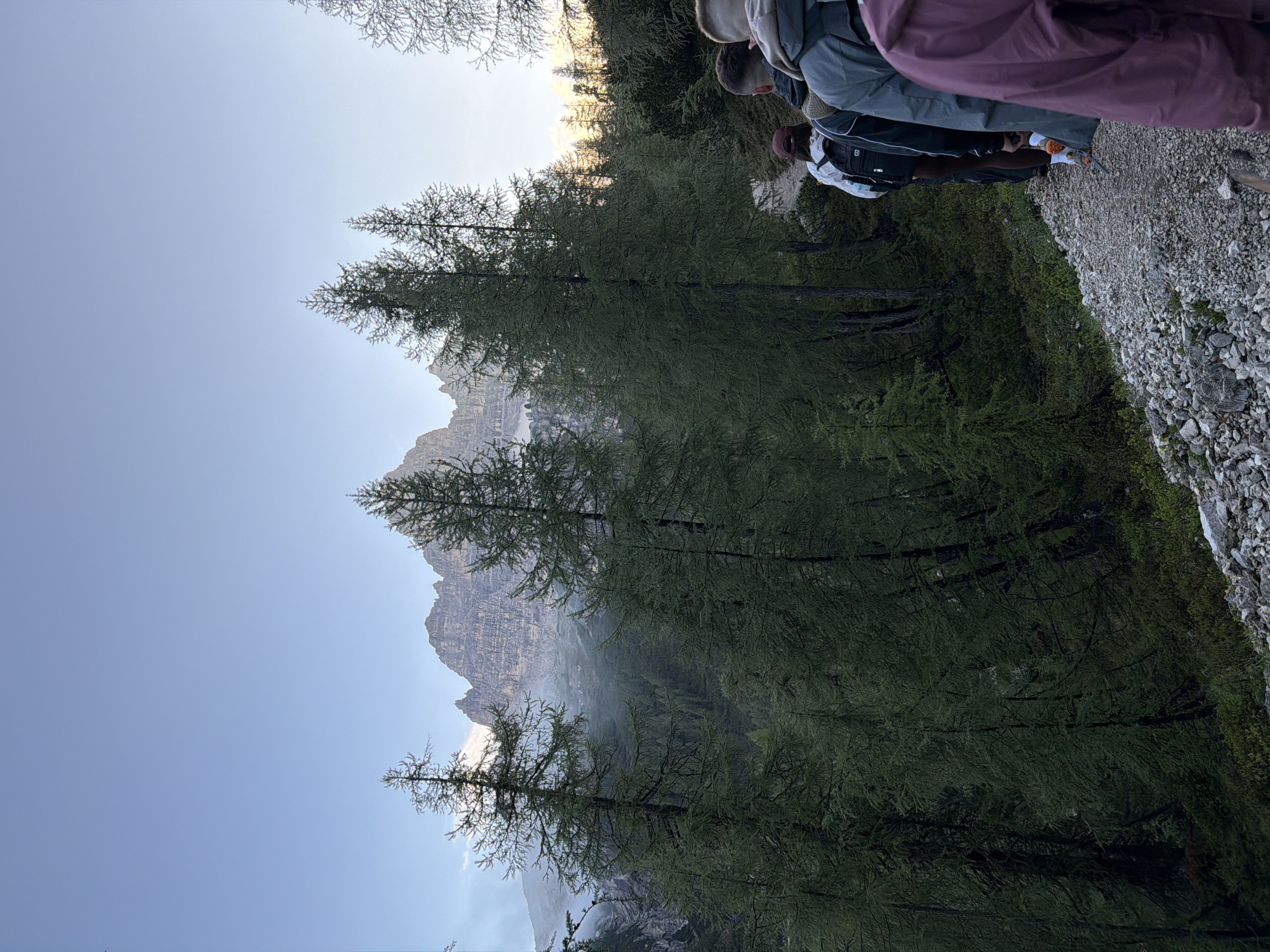 Early morning hikers traverse mountain trails in Italian Alps