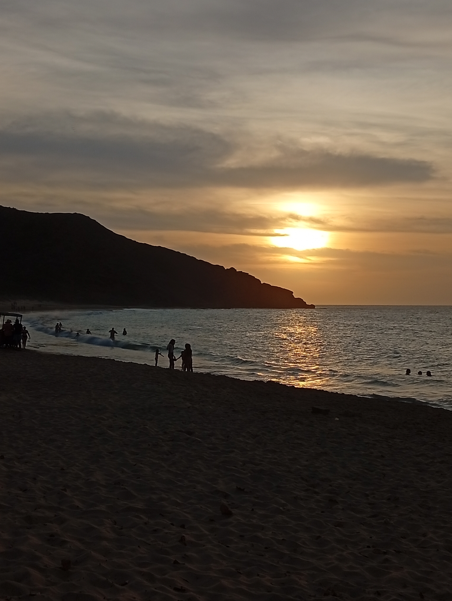 Woman enjoys sunset beach scene in Venezuela