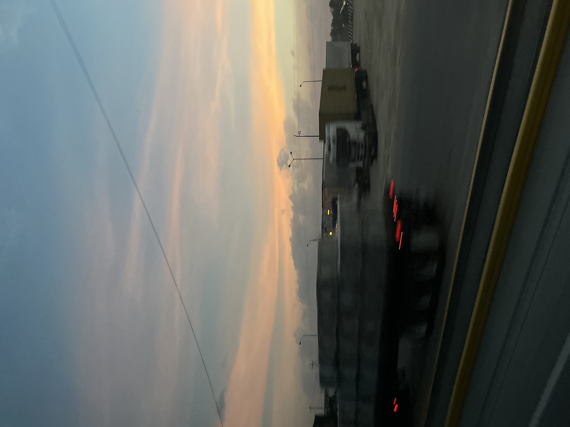 Semi-trucks lined highway at dusk in Mexico