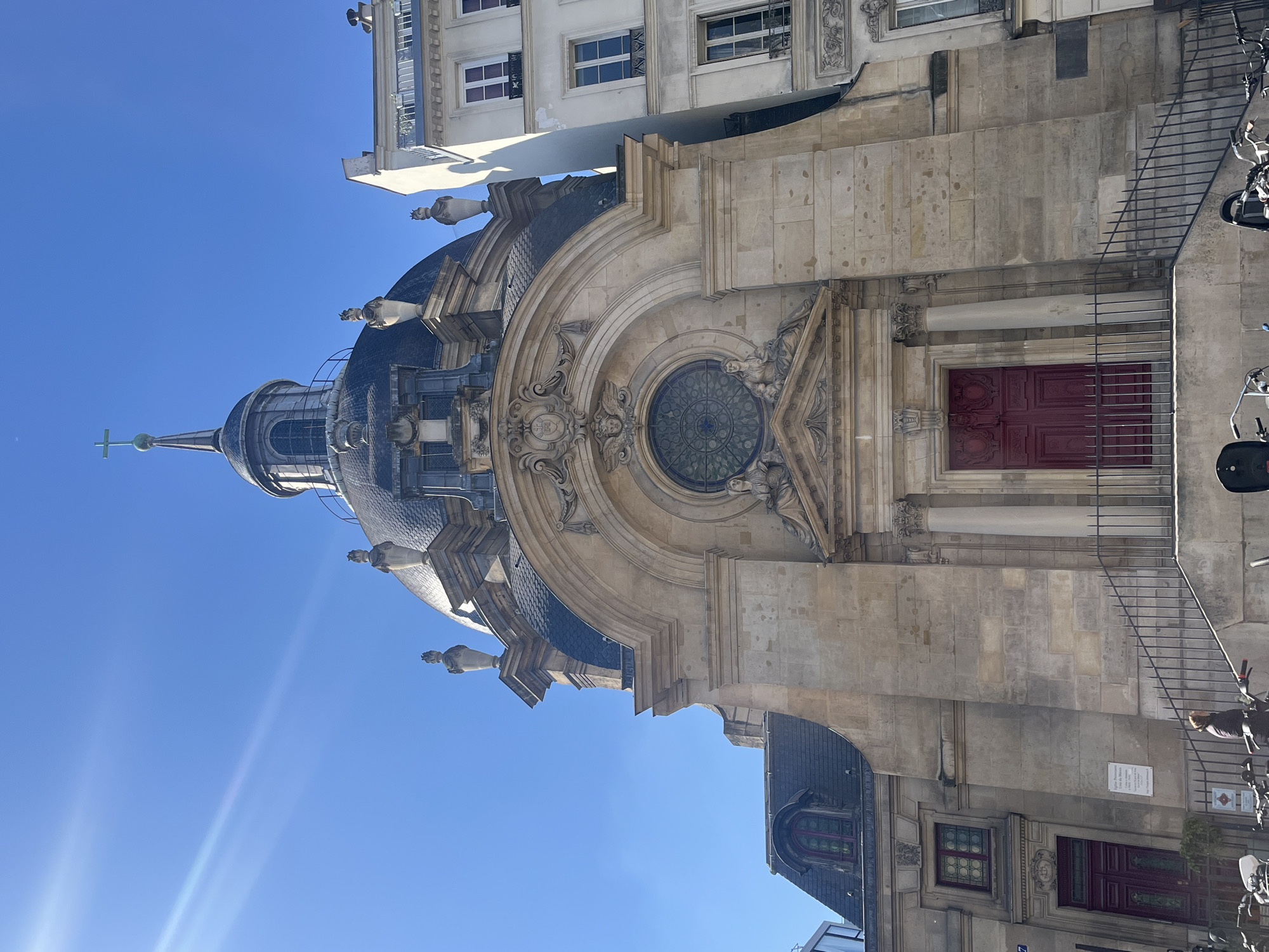 Historic domed building photographed under clear skies in Paris