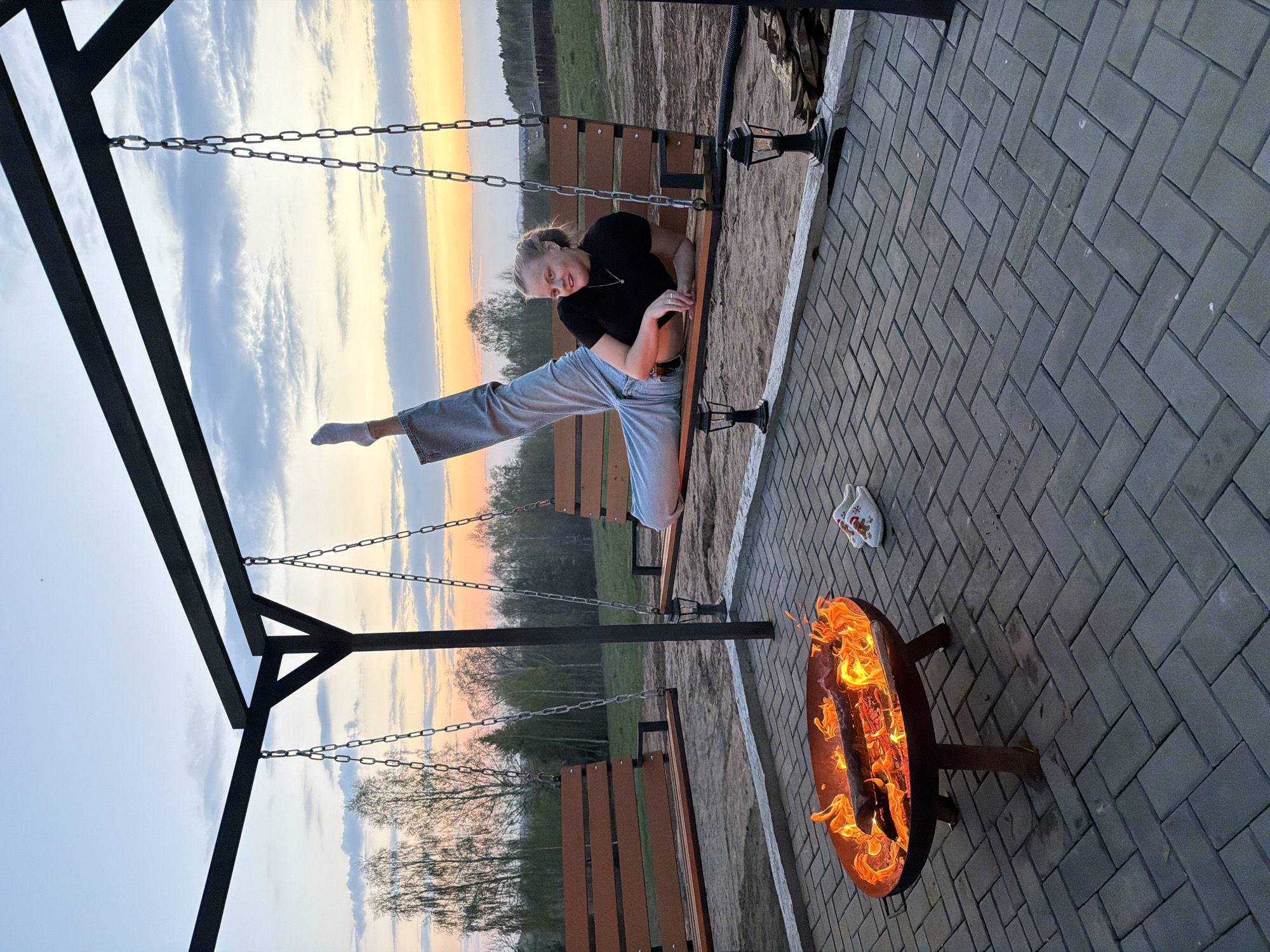Woman enjoys evening fire pit gathering in Kamennoye, Russia