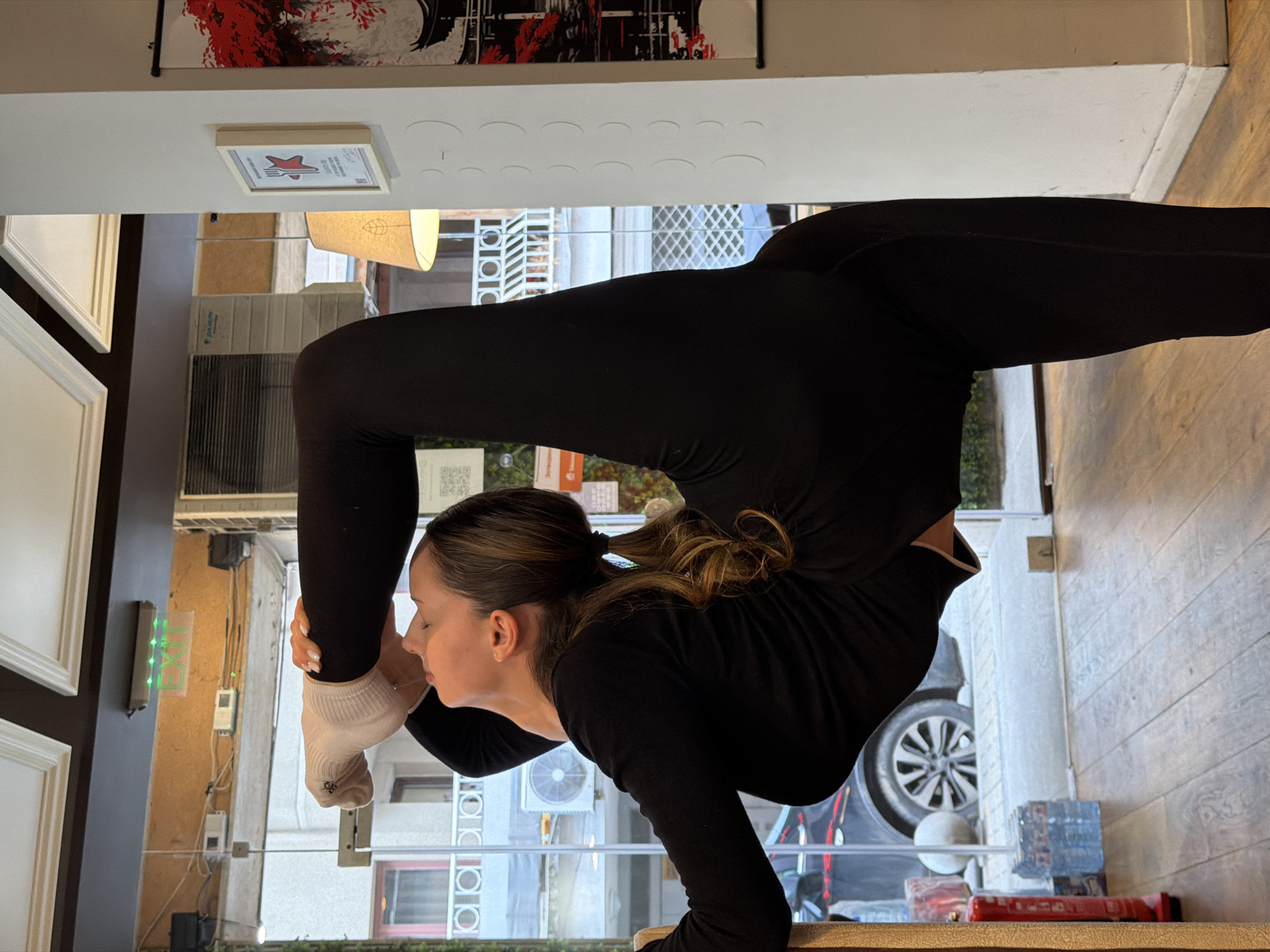 Woman performs yoga routine in Sofia cafe