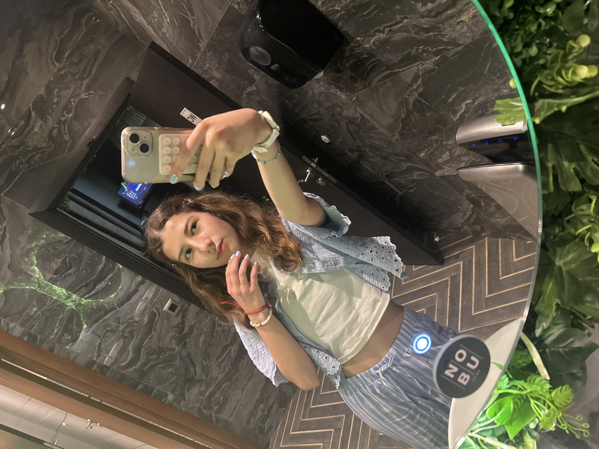Woman takes bathroom selfies at Nobu restaurant in Bulgaria