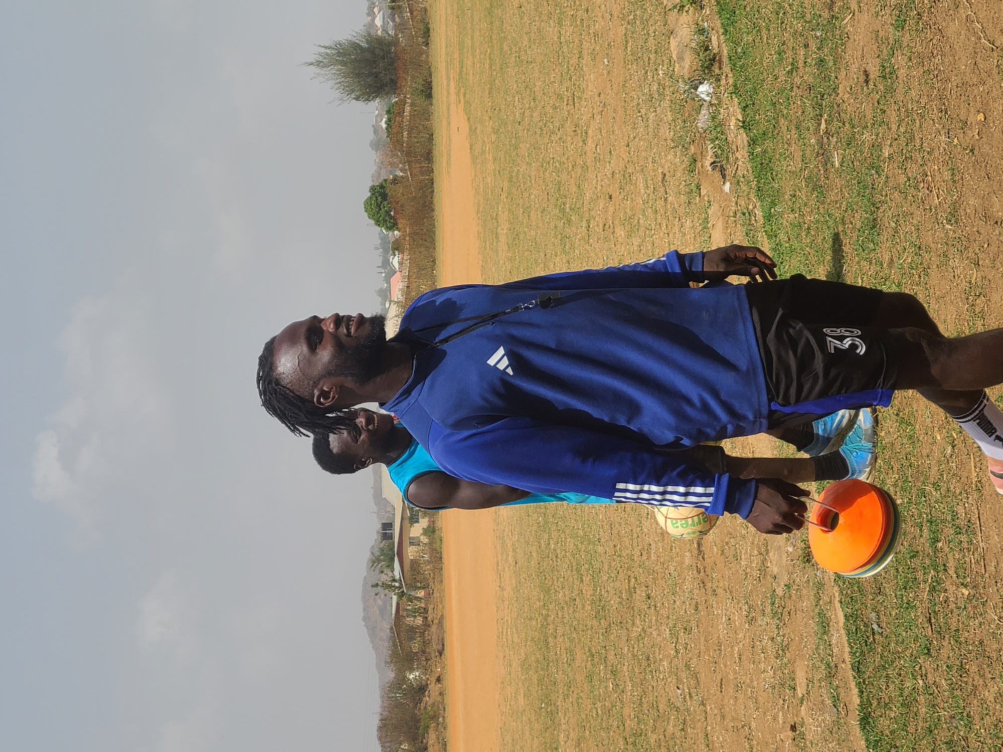 Young men gather for sports training in Nigerian field