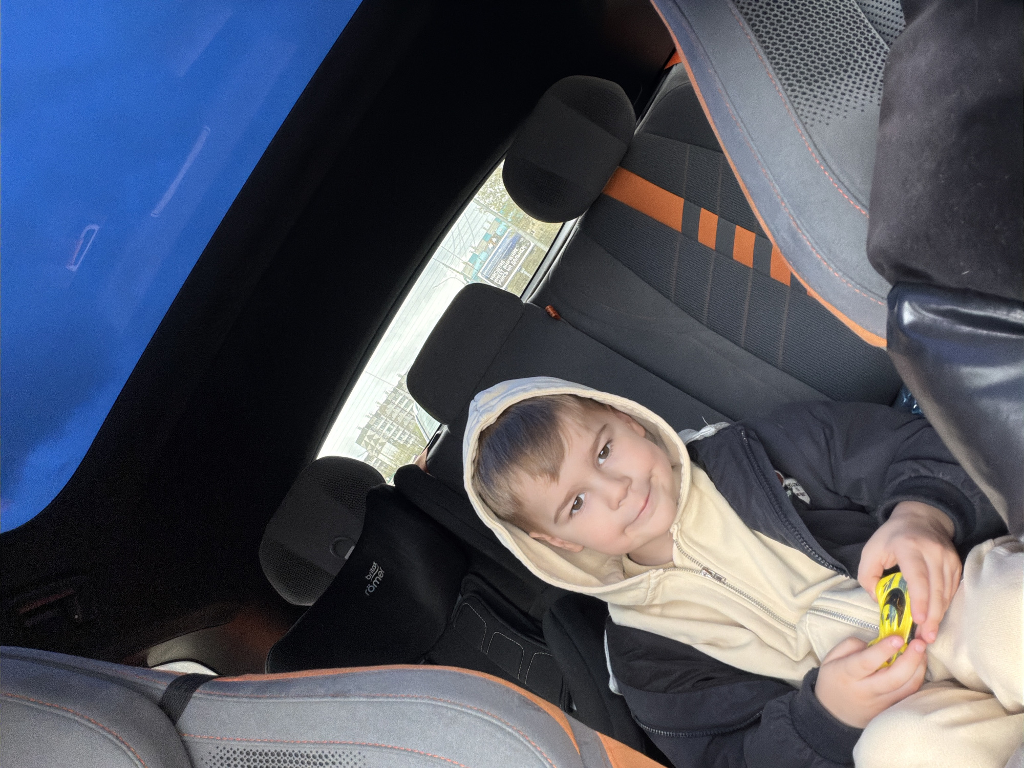 Boy sits in car with sunroof in Krasnoyarsk