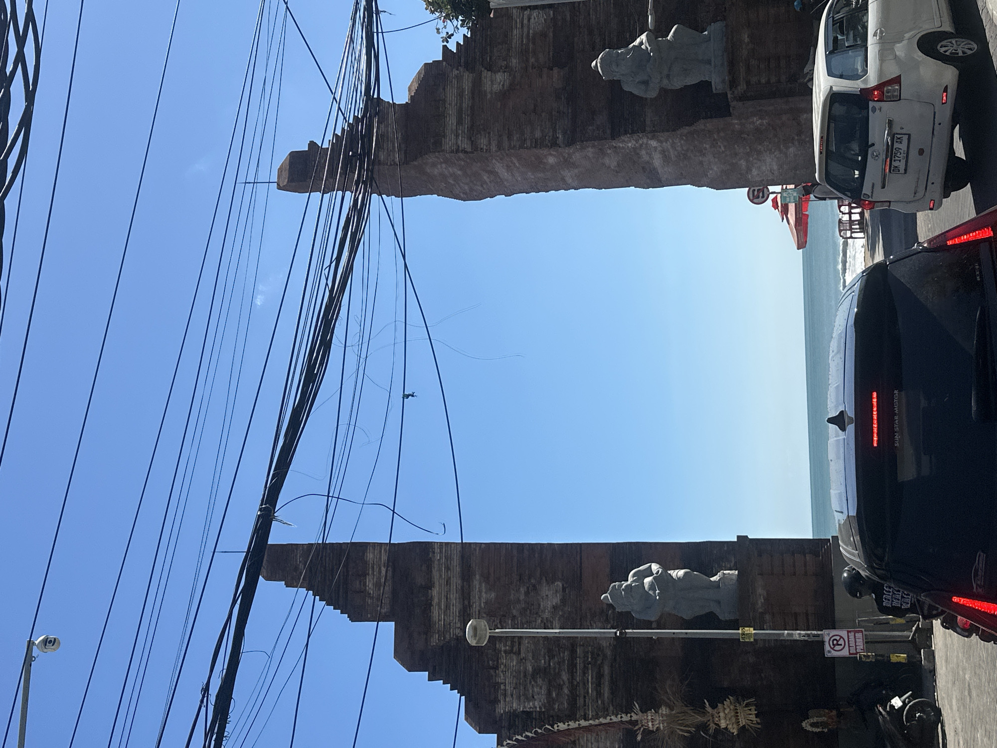 Kuta's commercial streets: traffic, vendors, and Balinese storefronts