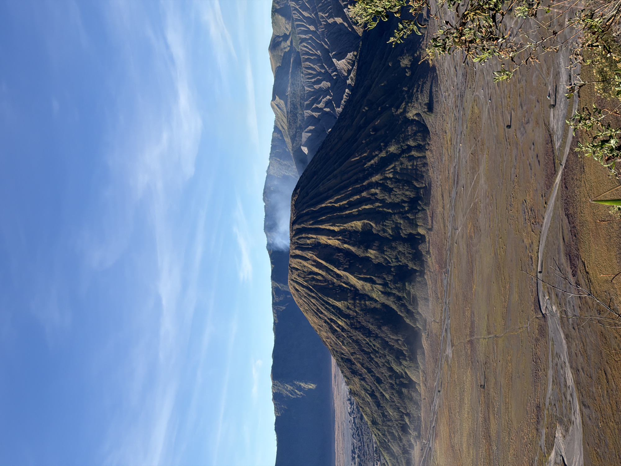 Mount Bromo's barren caldera under clear skies, Tosari