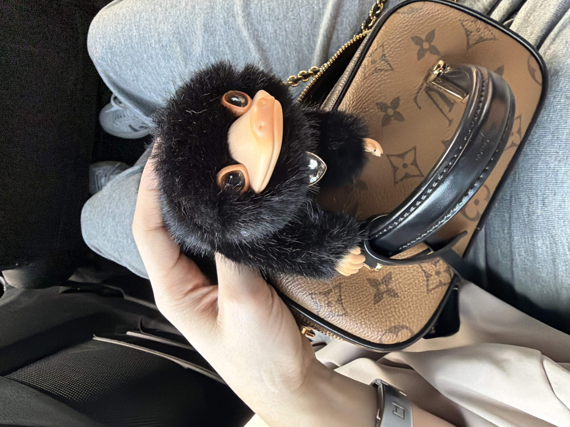 Woman displays Louis Vuitton bag with Niffler charm in Beijing