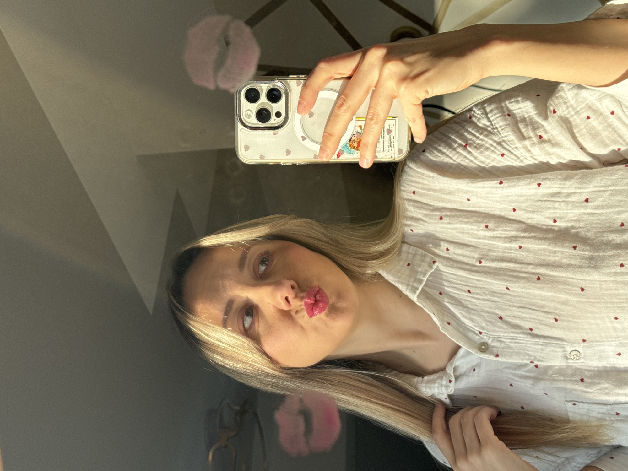 Woman takes morning selfies while styling hair in Latvia